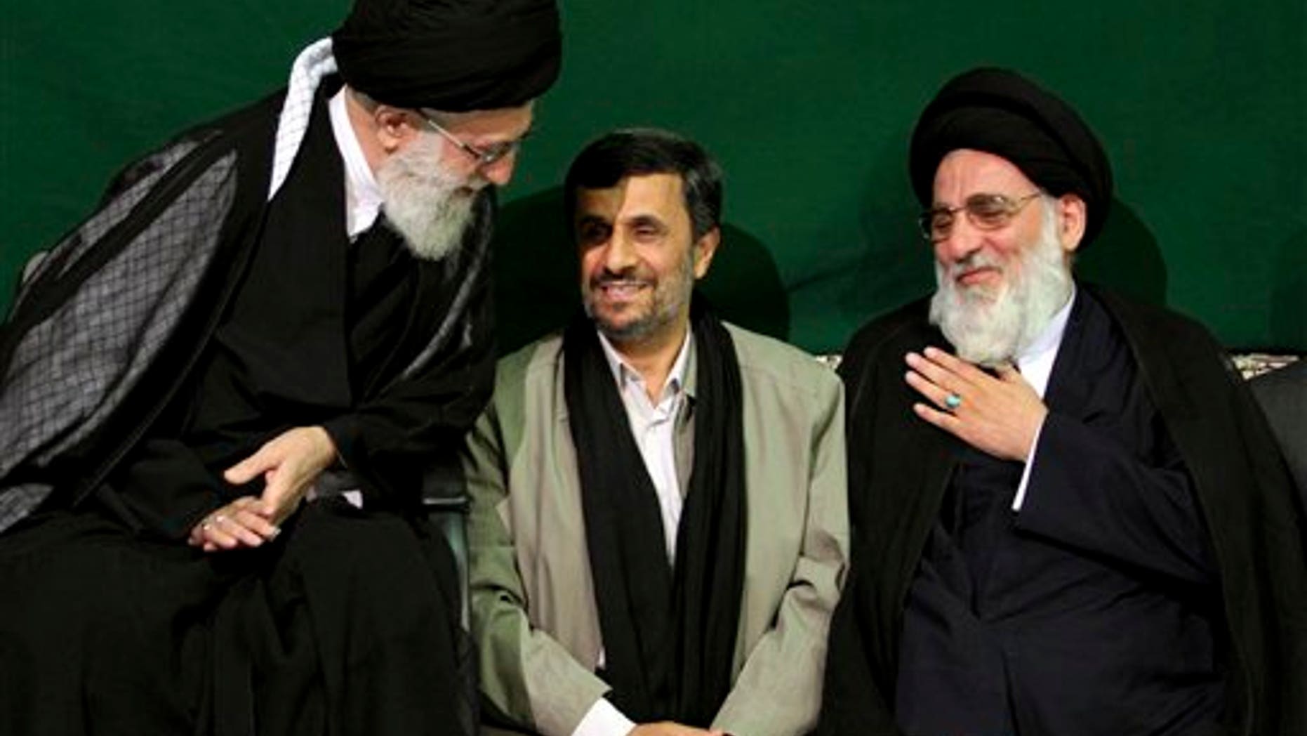 May 7, 2011: Iranian supreme leader Ayatollah Ali Khamenei, left, greets former Judiciary chief Ayatollah Mahmoud Hashemi Shahroudi, right, as President Mahmoud Ahmadinejad sits at center, during a religious ceremony, in Tehran, Iran.