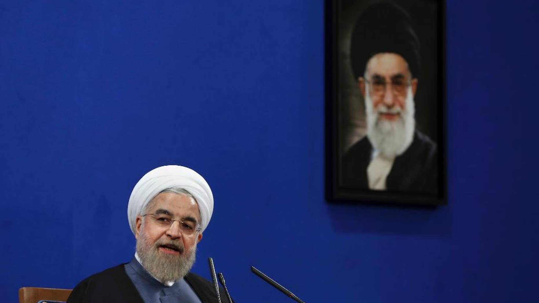 FILE - In this Saturday, June 13, 2015 file photo, Iranian President Hassan Rouhani speaks during a press conference on the second anniversary of his election in Tehran, Iran. A picture of the supreme leader Ayatollah Ali Khamenei hangs on the wall. Should the talks over Iran's nuclear program collapse, the alternatives are not appealing: the war option that the United States has kept on the table has few fans, and the world does not seem willing to truly bring Iran to its knees by shutting off the flow of capital and goods. (AP Photo/Ebrahim Noroozi, File)