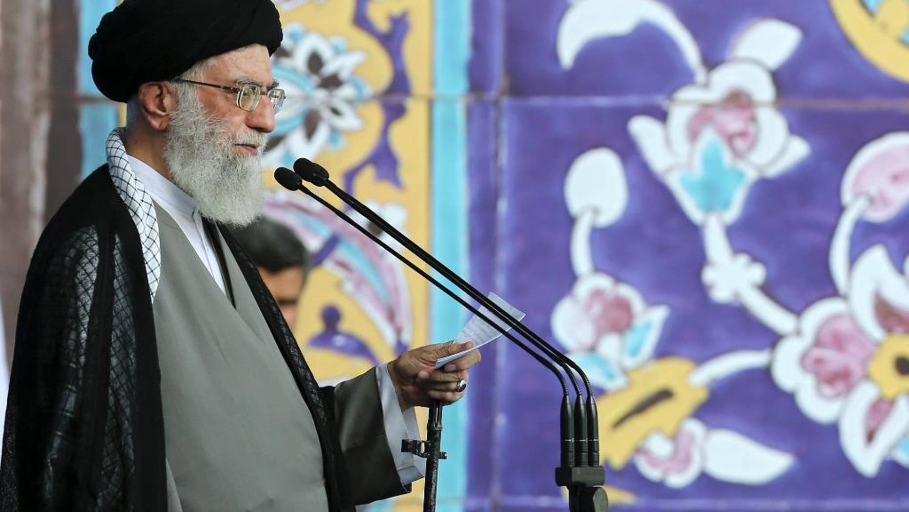 In this picture released by an official website of the office of the Iranian supreme leader on Saturday, July 18, 2015, Supreme Leader Ayatollah Ali Khamenei delivers his sermon during the Eid al-Fitr prayer at the Imam Khomeini Grand Mosque in Tehran, Iran. Khamenei said a historic nuclear deal with world powers reached this week won't change Iran's policy towards the "arrogant" government of the United States. (Office of the Iranian Supreme Leader via AP)