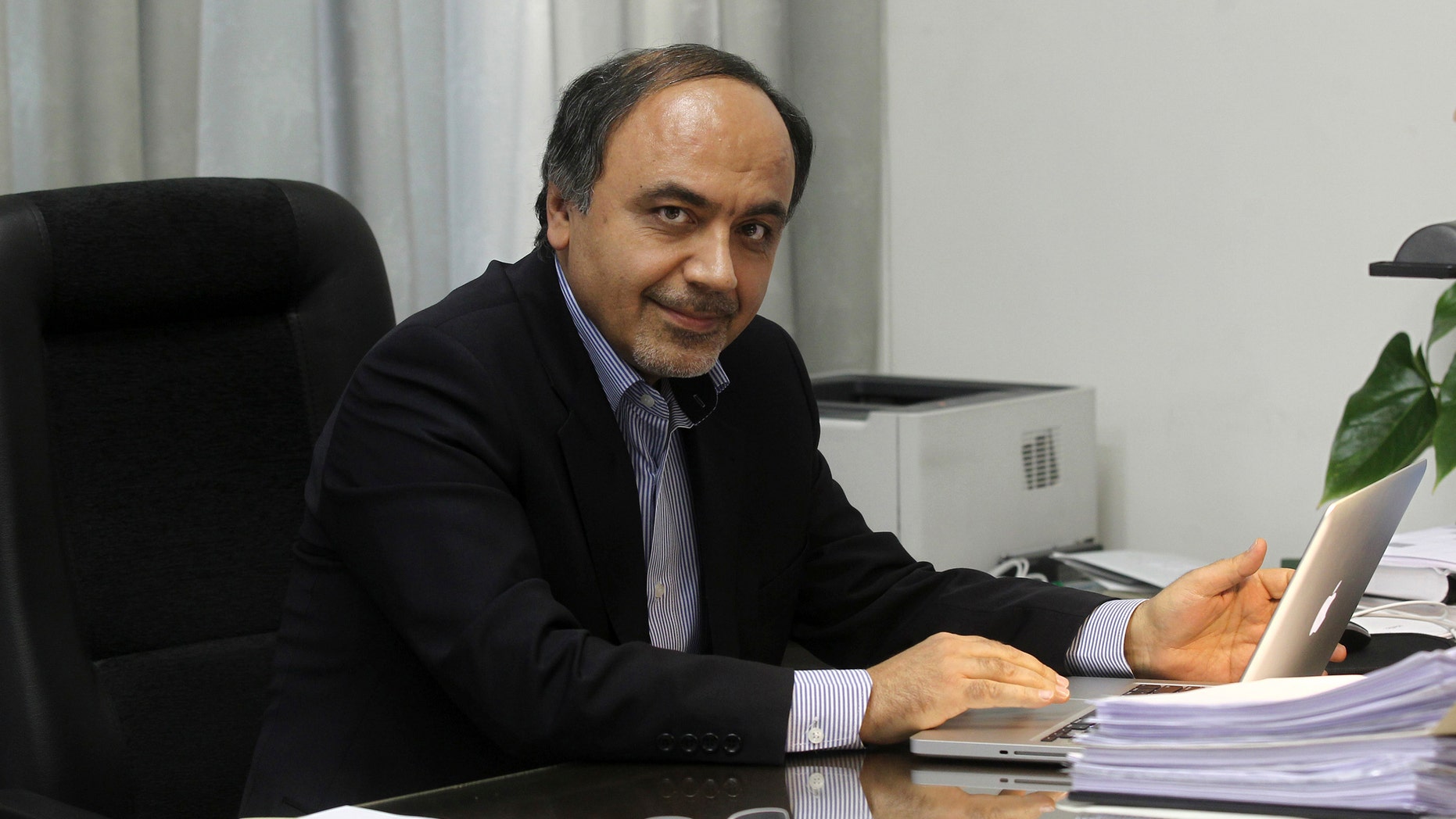 April, 12, 2014: In this undated photo provided by the office of the Iranian President, Hamid Aboutalebi, an Iranian diplomat, who was recently named as Iran's ambassador at the United Nations, sits in his office in Tehran, Iran.