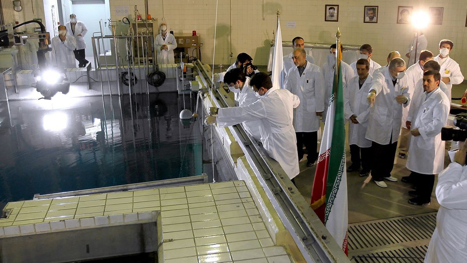 FILE- In this Feb. 15, 2012, file photo, provided by the Iranian President's Office, Iranian President Mahmoud Ahmadinejad, right, is escorted by technicians during a tour of Tehran's research reactor center in northern Tehran, Iran. Iran's envoys are heading for nuclear talks with confidence that the chips are falling their way. Iran's denials that it is trying to develop nuclear weapons carry a distinctly hollow ring among its foes as the U.N. nuclear watchdog piles on worries: Complaining about limits on inspection access and reporting that Tehran is expanding its nuclear fuel labs. But, as Israel increasingly weighs the option of a military strike, Western leaders wary of another Middle East conflict may have to pay closer attention to the claims. (AP Photo/Iranian President's Office, File)