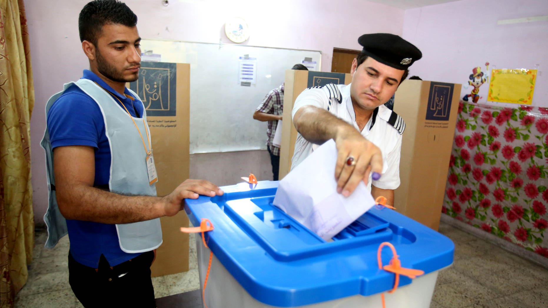 April 28, 2014 - An Iraqi traffic policeman casts his vote at a polling center in Baghdad, Iraq. Iraqi officials say suicide bombers have targeted polling centers as soldiers and security forces cast ballots ahead of parliamentary elections.