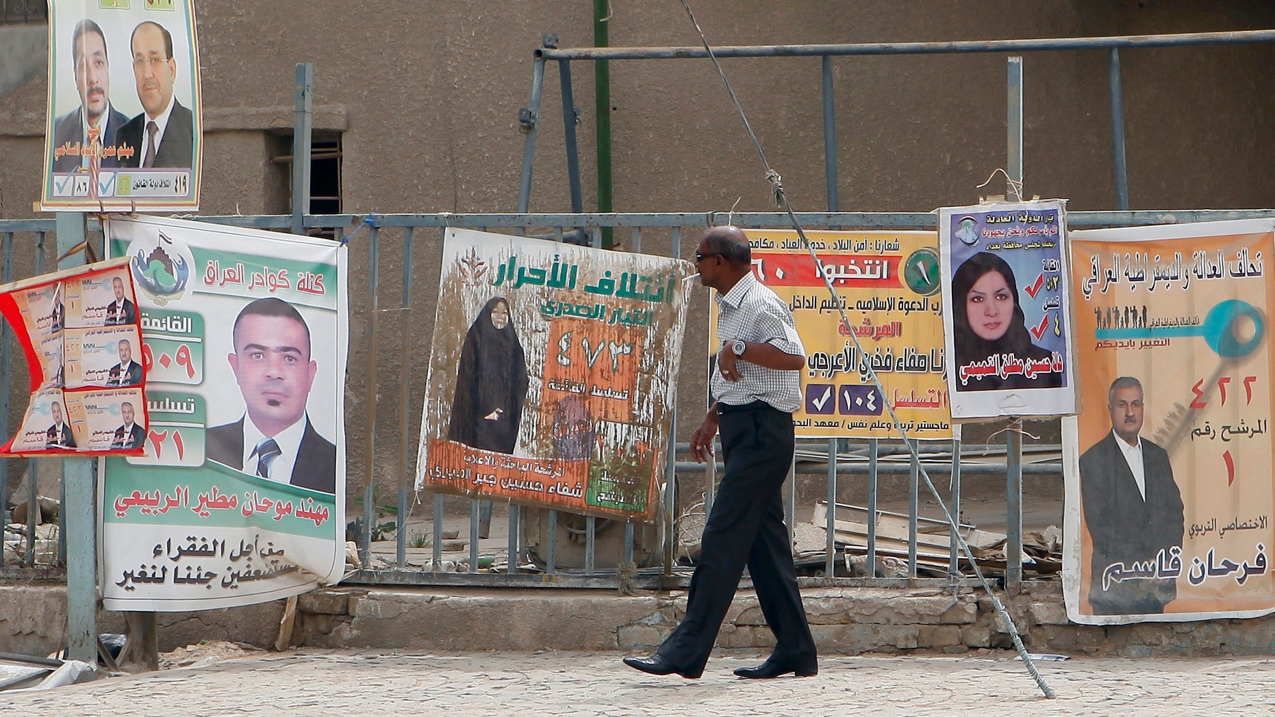 April 13, 2013: A man walks past election posters in Baghdad, Iraq.