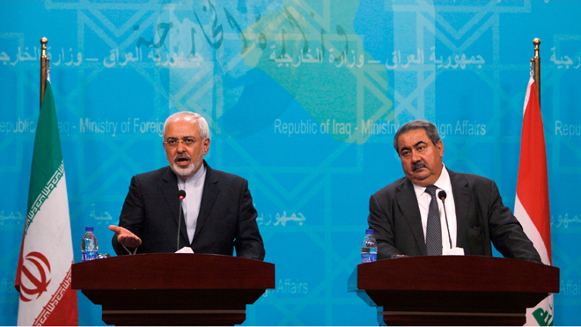 Iranian Foreign Minister Mohammad Javad Zarif, left, standing next to his Iraqi counterpart Hoshyar Zebari, speaks during a press conference in Baghdad, Iraq, Sunday, Aug. 24, 2014.
