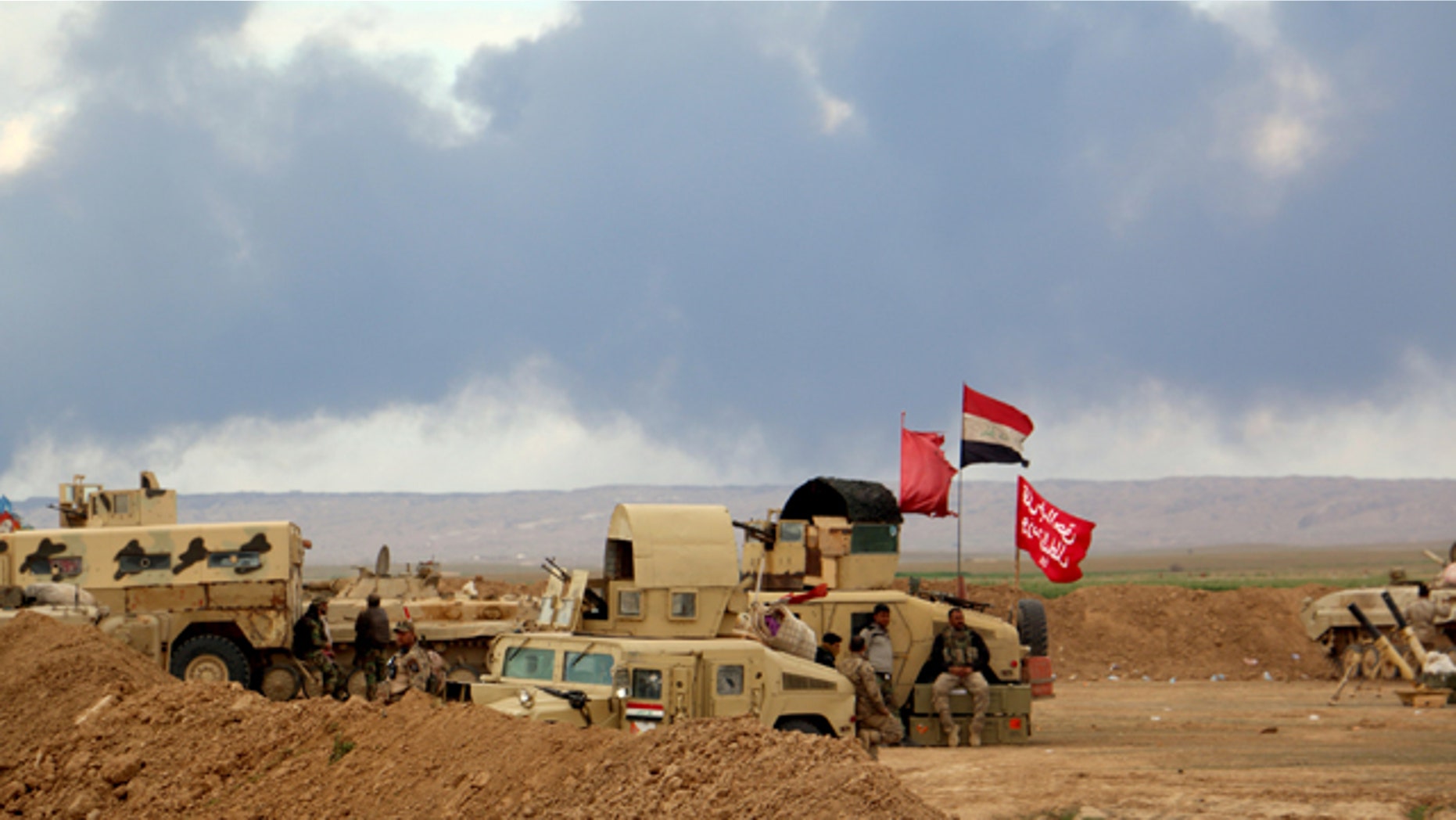 March 4, 2015: Smoke rises as the Iraqi army, supported by volunteers, battles Islamic State extremists outside Tikrit, 80 miles north of Baghdad. (AP Photo)