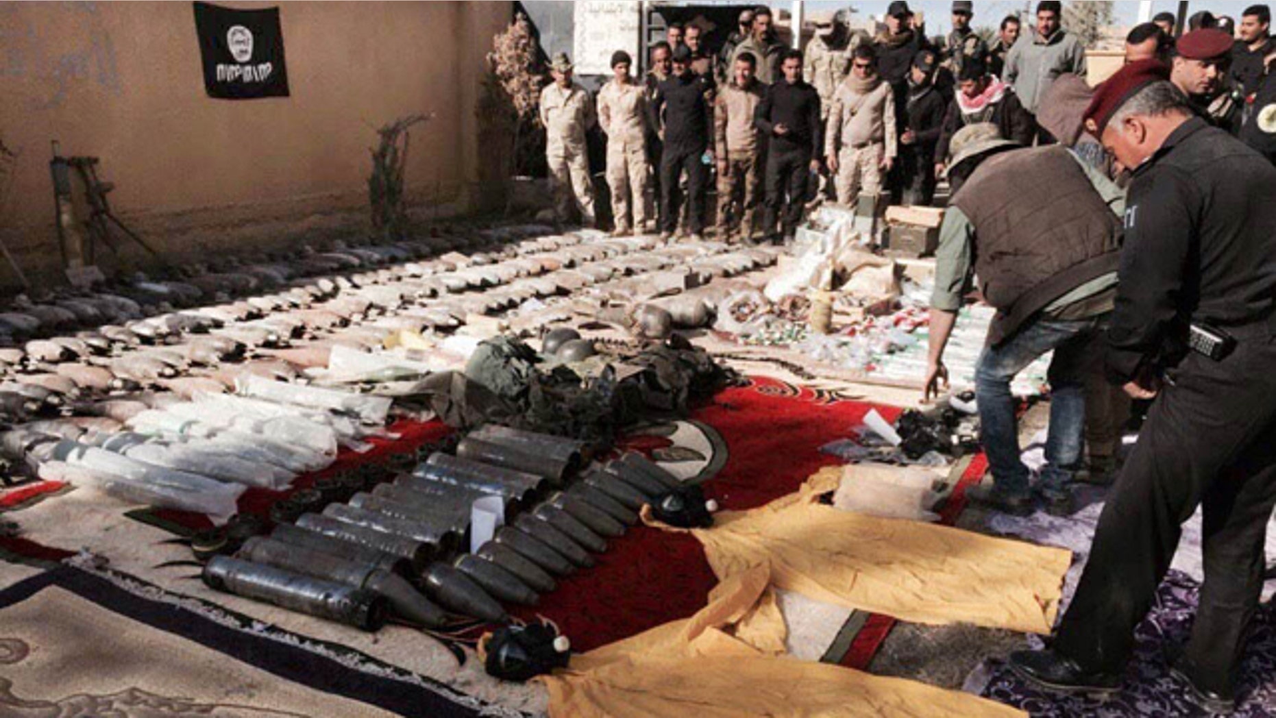 Dec. 10, 2015: Iraqi security forces look at confiscated ISIS weapons and ammunition after regaining control over the last week, in Ramadi, Anbar province, 70 miles west of Baghdad. (AP Photo/Osama Sami)