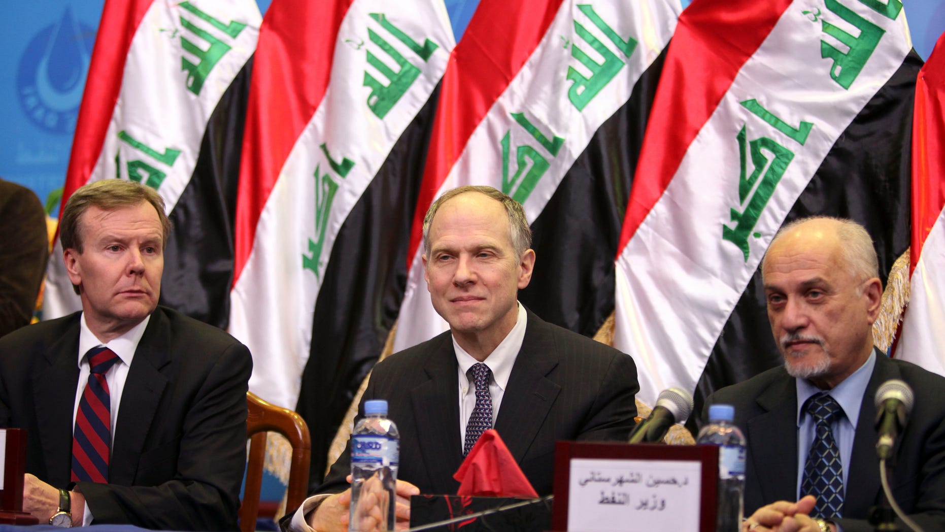 Jan. 25, 2010: From left, ExxonMobil Corp. President Robert S. Franklin, ExxonMobil Corp. Director Richard C. Vierbuchen and then Iraqi Oil Minister Hussain al-Shahristani, are seen during a signing ceremony in Baghdad, Iraq. An oil exploration deal between U.S. oil giant Exxon Mobil and Iraq’s autonomous Kurdish region is fueling political tensions in a country where a post-U.S.-troop withdrawal spike in violence and political turmoil is clouding the climate for foreign investments sorely needed by Iraq.
