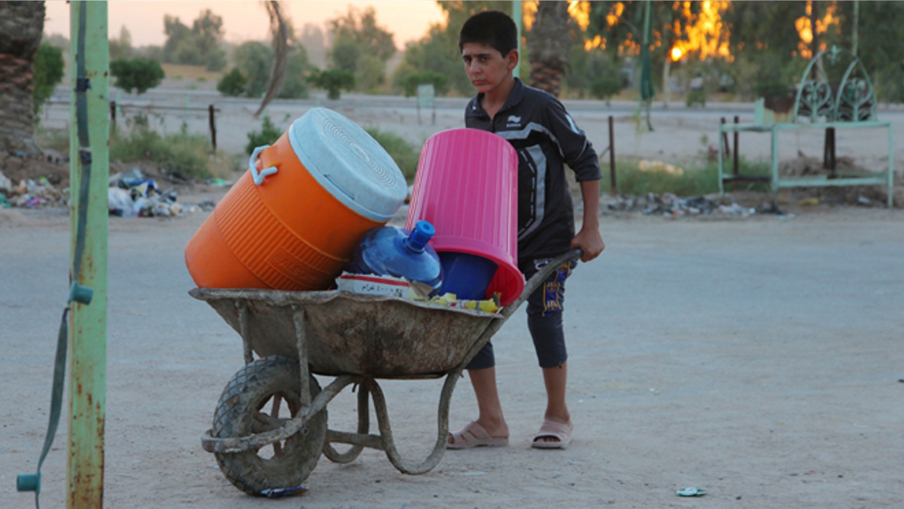 In this Aug. 4, 2014, photo, an Iraqi boy in a camp of displaced Iraqis who fled from their towns after advances by Islamic militants take shelter in Najaf, Iraq.