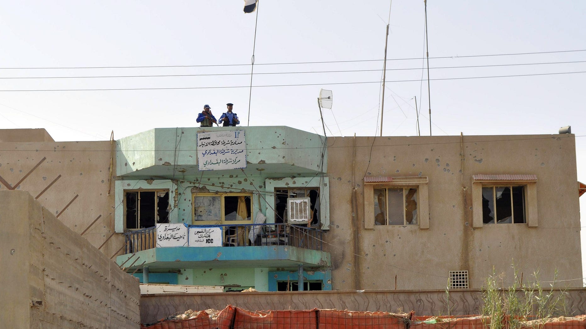 October 3: Iraqi police inspect the damaged at their police station in al-Baghdadi west of Ramadi, 70 miles (115 kilometers) west of Baghdad, Iraq.