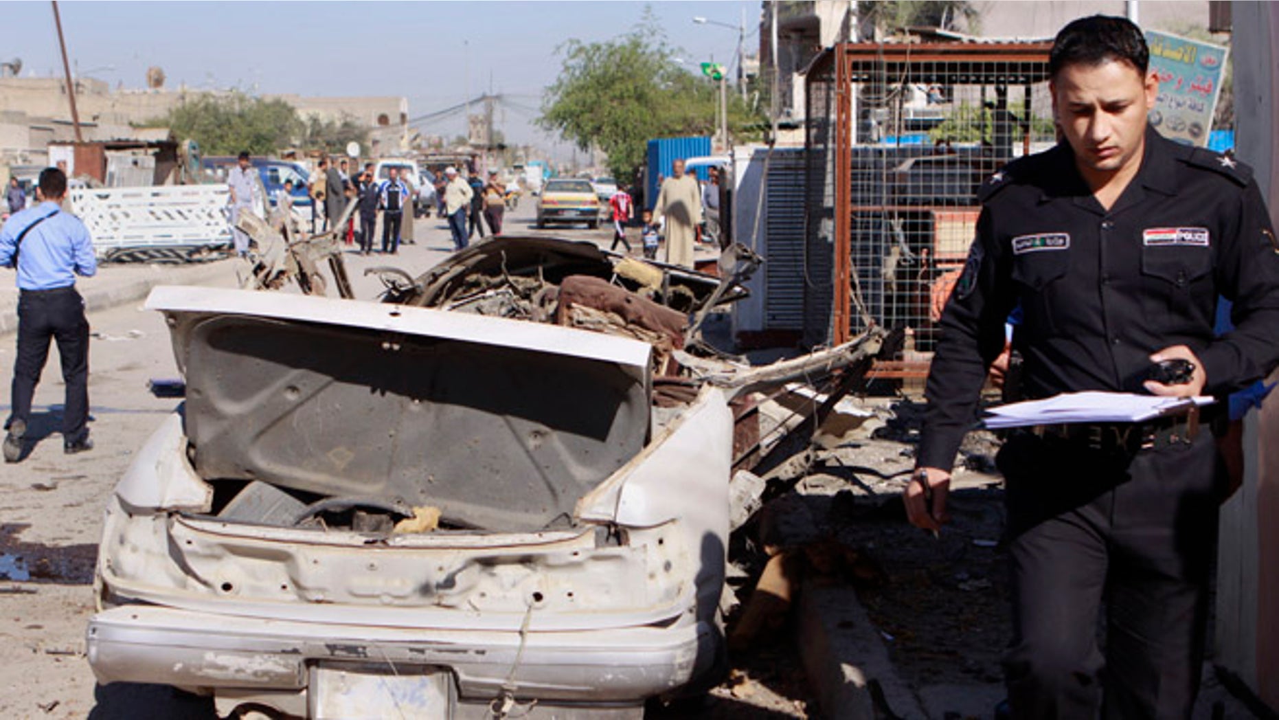 March 19, 2013: A policeman inspects the scene of a car bomb attack in the Shiite stronghold of Sadr City, Baghdad, Iraq.