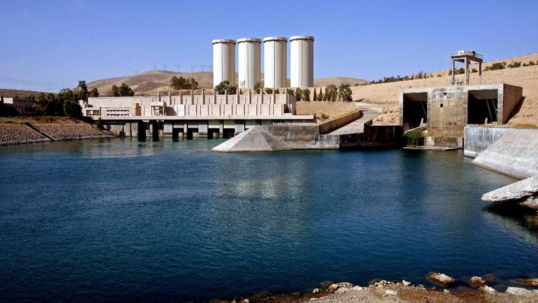 FILE - This Oct. 31, 2007 file photo, shows a general view of the dam in Mosul, 360 kilometers (225 miles) northwest of Baghdad, Iraq. The rapid advance of the Islamic State group, which captured Iraq's second largest city of Mosul and declared a self-styled Islamic Caliphate straddling the Iraq-Syria border, has plunged Iraq into its worst crisis since U.S. troops withdrew in 2011. Experts say the strategy for capturing the dams is twofold. First, seizing dams and large reservoirs can be used as a military tactic. Flooding the terrain slows any possible encounters with military tanks and foot soldiers, giving the militants freedom of movement, if briefly. (AP Photo/ Khalid Mohammed, File)