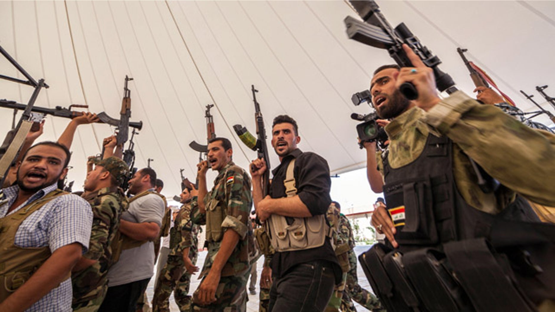 June 25, 2014: An Iraqi volunteer force chant slogans against the Al Qaeda-inspired Islamic State of Iraq and the Levant during training in the Shiite holy city of Karbala, 50 miles south of Baghdad. (AP Photo/Ahmed al-Husseini)