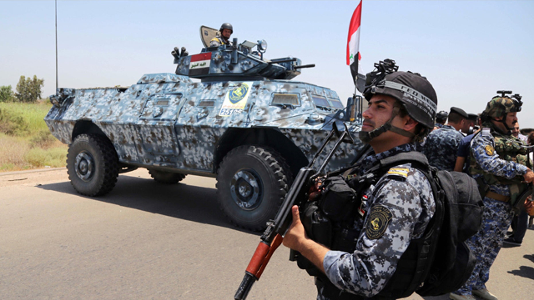 June 28, 2014: Iraqi federal policemen patrol in Baghdad's Abu Ghraib suburb. Iraqi troops backed by helicopter gunships launched an operation early Saturday aimed at dislodging Sunni militants from the northern city of Tikrit, one of two major urban centers they seized in recent weeks in a dramatic blitz across the country. (AP Photo/Karim Kadim)