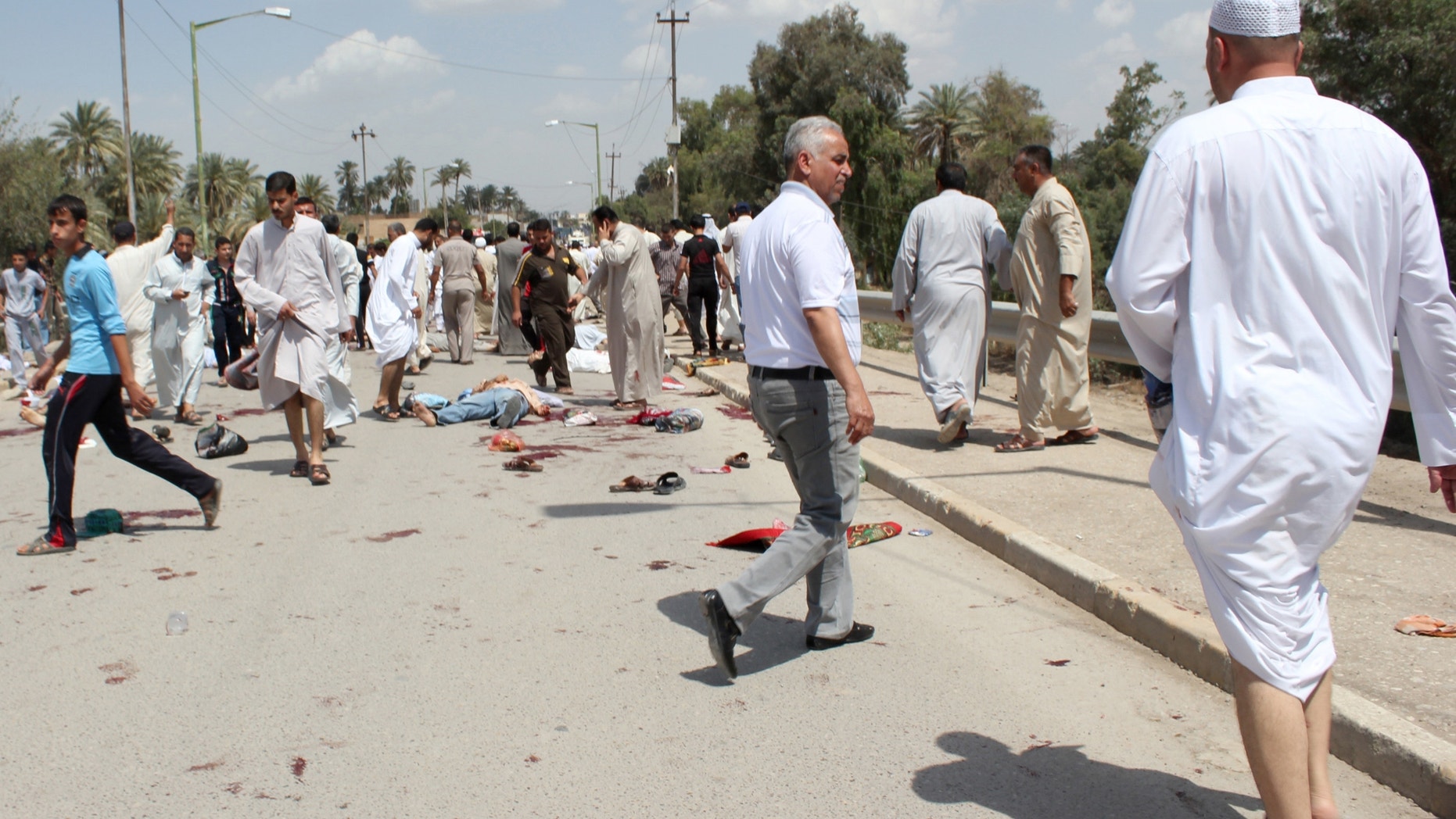 May 17, 2013 - Iraqis gather at the scene of a bomb attack in Baqouba, northeast of Baghdad, Iraq.