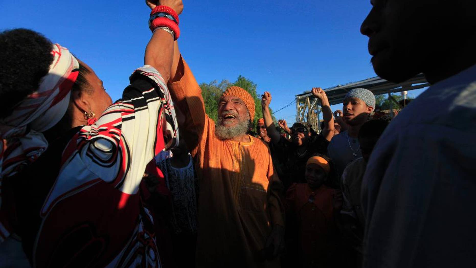 FILE - In this file photo taken Sunday, June 7, 2009, Ben Ammi Ben Israel, the spiritual leader of the African Hebrew Israelites of Jerusalem, is greeted by the crowd during festivities marking the holiday of Shavuot in the southern Israeli town of Dimona. The spiritual leader of the African Hebrew Israelites, a polygamous vegan group that believes some black Americans descended from a Jewish tribe, died Saturday, Dec. 27, 2014, at age 75, the group announced Sunday. (AP Photo/Tsafrir Abayov, File)