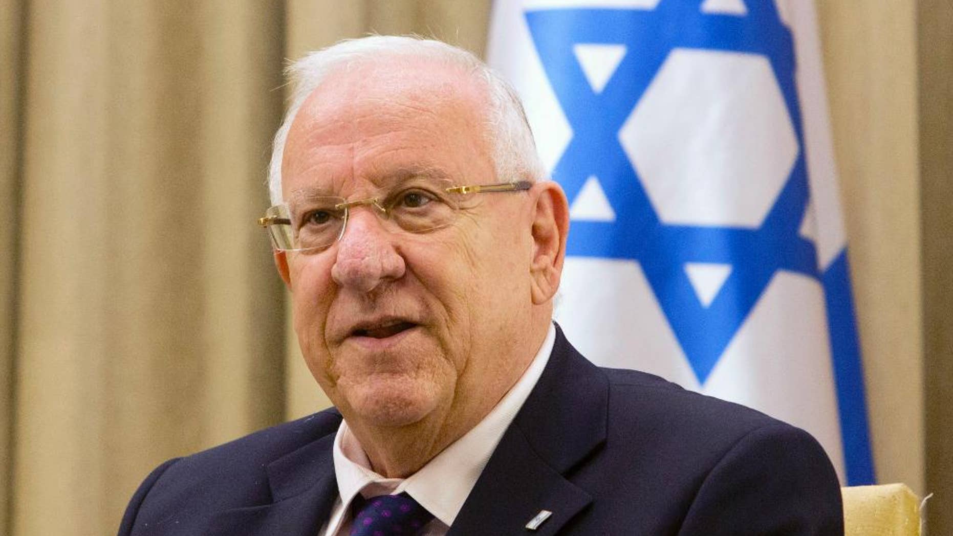 FILE - In this Nov. 3, 2014 file photo, Israel's President Reuven Rivlin, attends a meeting at the President's residence in Jerusalem. A canceled bar mitzvah ceremony for boys with disabilities is highlighting a rift between Israel's Orthodox majority and its more marginal streams of Judaism. President Reuven Rivlin had agreed to hold the ceremony at his residence but later suggested a non-religious event. (AP Photo/Sebastian Scheiner, File)