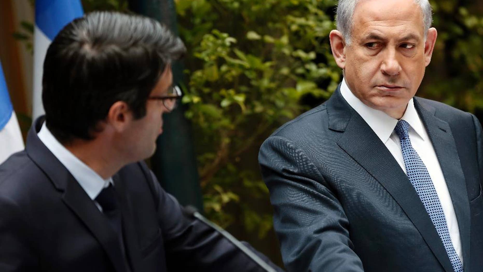 Israeli Prime minister Benjamin Netanyahu, right, stands next to French Ambassador to Israel, Patrick Maisonnave, as he presents his condolences following Wednesday's deadly attack on French satirical newspaper Charlie Hebdo's offices, at the prime minister's residence in Jerusalem on Friday, Jan. 9, 2015. Brothers suspected in the newspaper terror attack were cornered with a hostage inside a printing house on Friday, after they hijacked a car and police followed them to a village near Paris' main airport. (AP Photo/Thomas Coex, Pool)