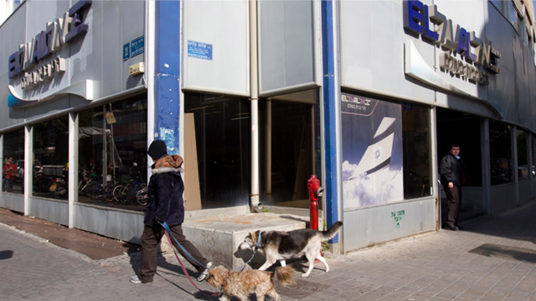 Jan. 16, 2012: A security guard, right, stands at the entrance of the national Israeli air carrier El Al sales offices in Tel Aviv, Israel. Hackers disrupted the websites of Israel's stock exchange and El Al on Monday in a deepening cyberwar launched earlier this month by a group claiming to be Saudis.
