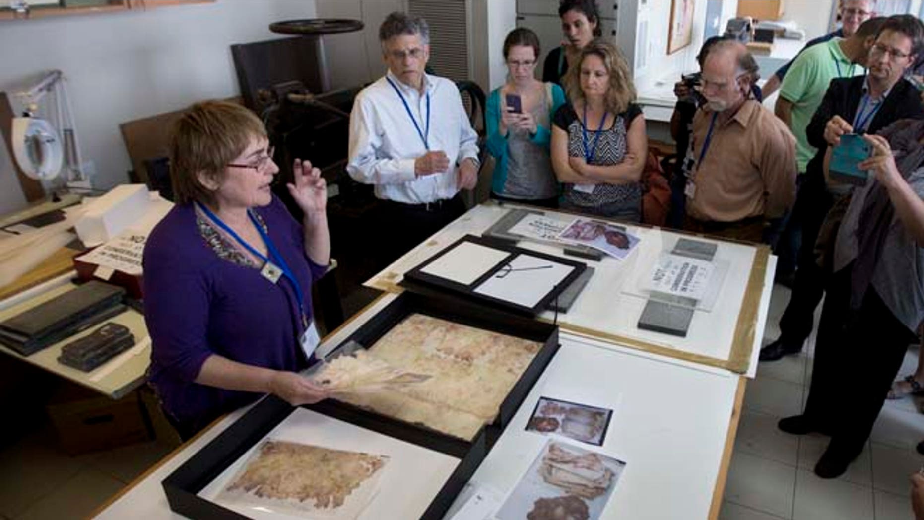 Sept. 8, 2014: In this photo, a worker shows restored documents at the Yad Vashem Holocaust memorial paper conservation laboratory to visiting international experts and others participating in a workshop devoted to the physical and digital preservation of documents, in Jerusalem. (AP)