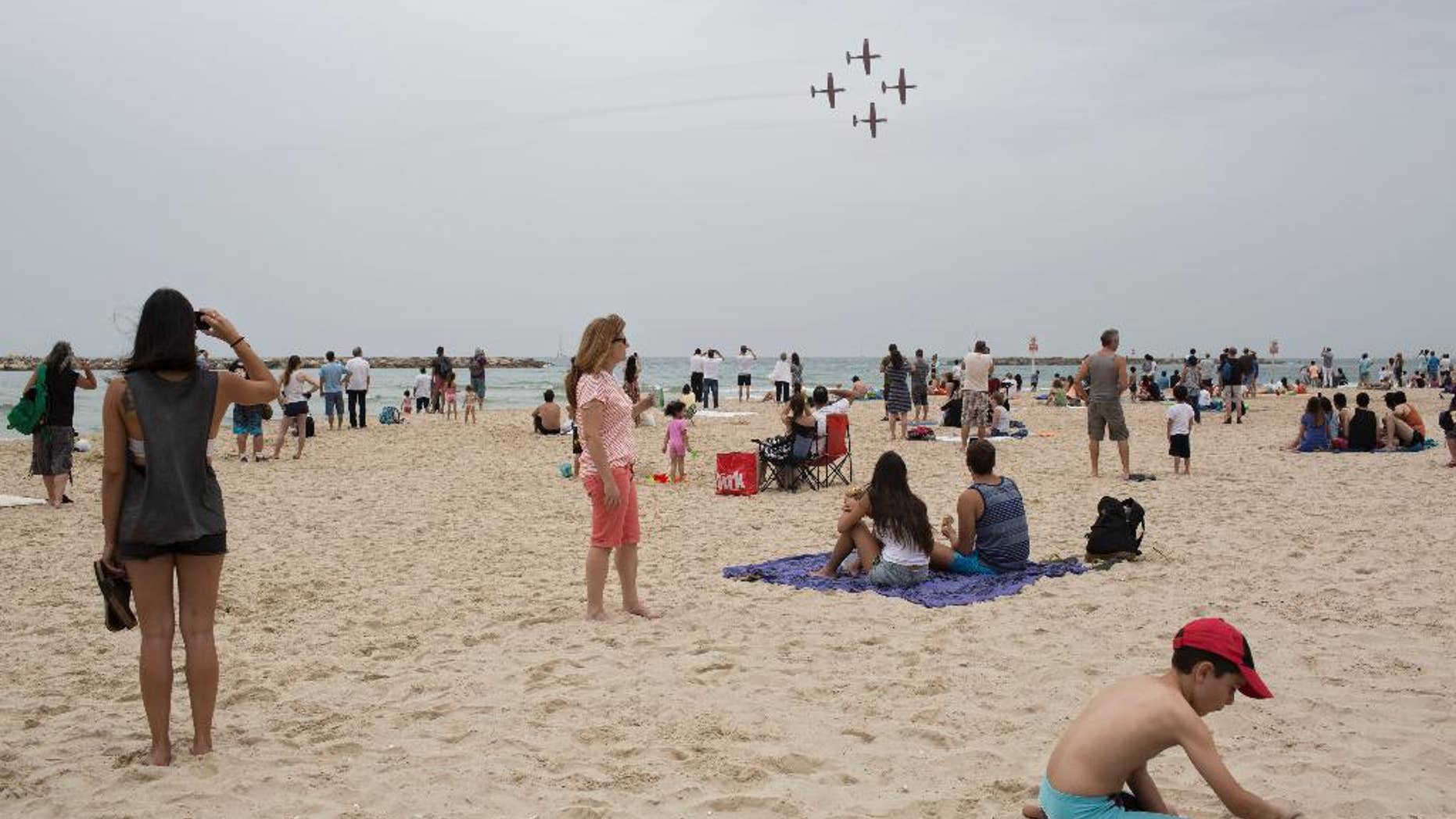 FILE - In this Tuesday, May 6, 2014 file photo, Israelis watch an air show during Independence Day in Tel Aviv. The world's Jewish population has grown to be nearly as large as it was before the Holocaust, an Israeli think tank said in its annual report Sunday, June 28, 2015. (AP Photo/Oded Balilty, File)