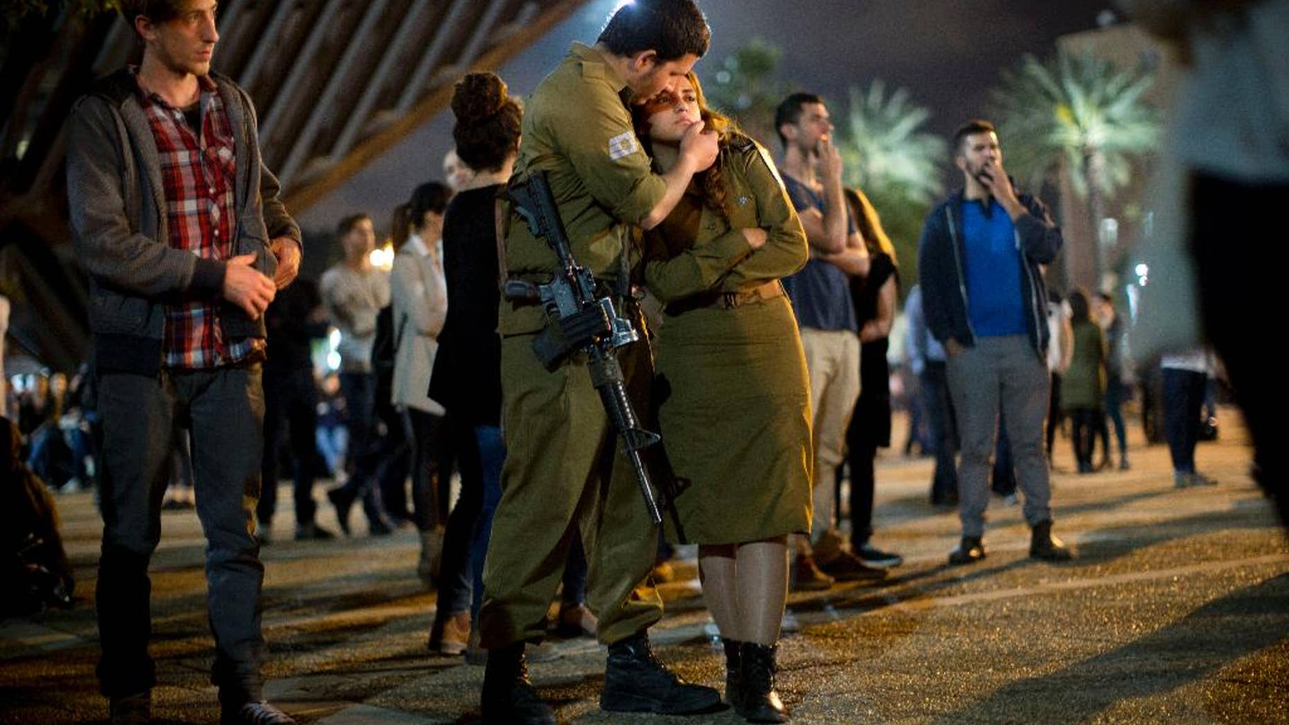 Israeli soldiers and other Israelis attend a ceremony marking Israel's annual Memorial Day for fallen soldiers, in Tel Aviv, Israel, Tuesday, April 21, 2015. (AP Photo/Oded Balilty)