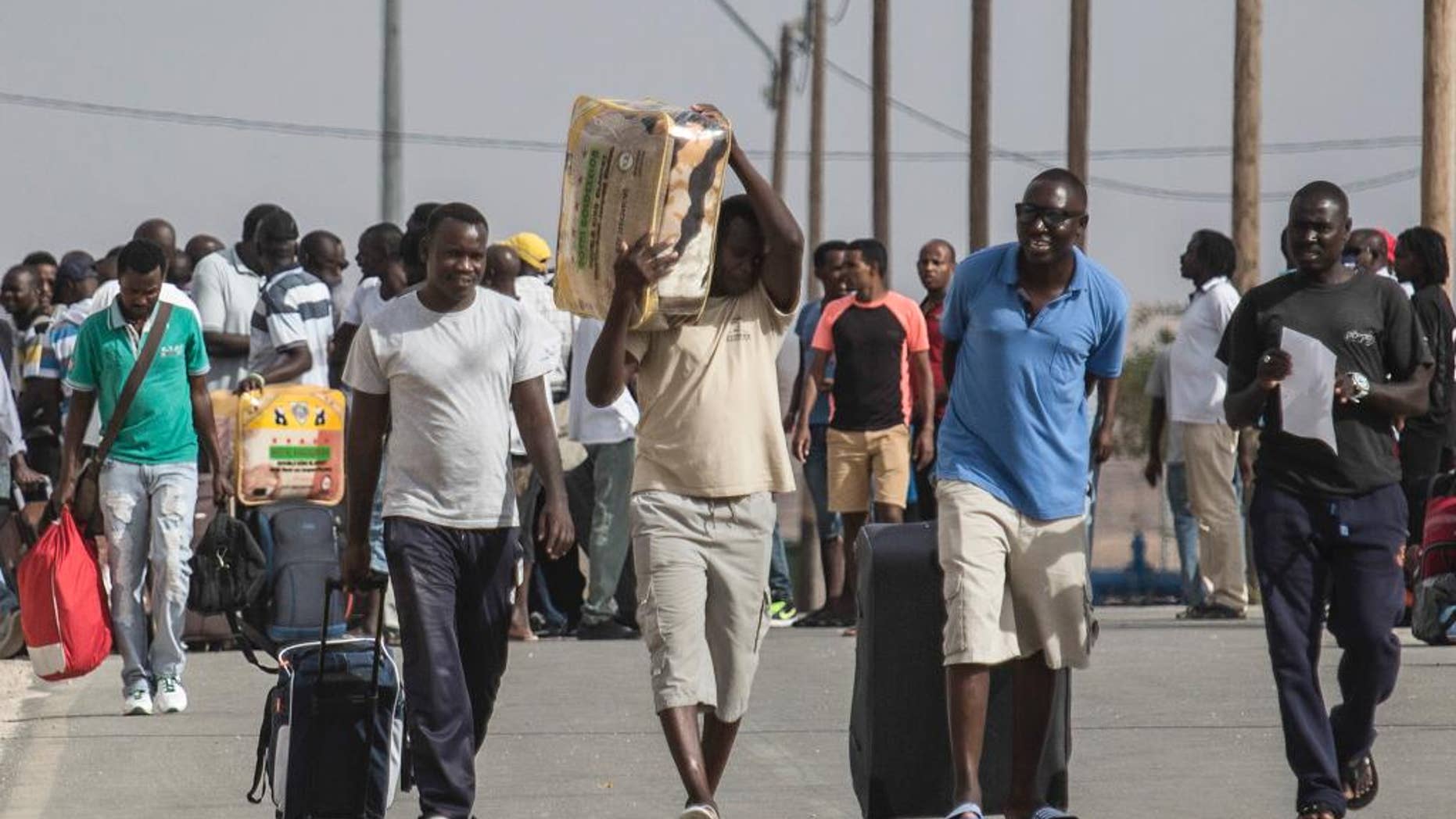 African illegal migrants walk out of the Holot detention center in the Negev desert in southern Israel, Tuesday, Aug. 25, 2015. Since it passed a 2012 “anti-infiltration” law, Israel has sent 1,700 migrants to the Holot facility deep in Israel’s Negev desert. Israel's Supreme Court upheld the law in the latest hearing but ruled that migrants held at Holot for more than 12 months must be freed. About 1,200 migrants are being released beginning Tuesday. (AP Photo/Tsafrir Abayov)
