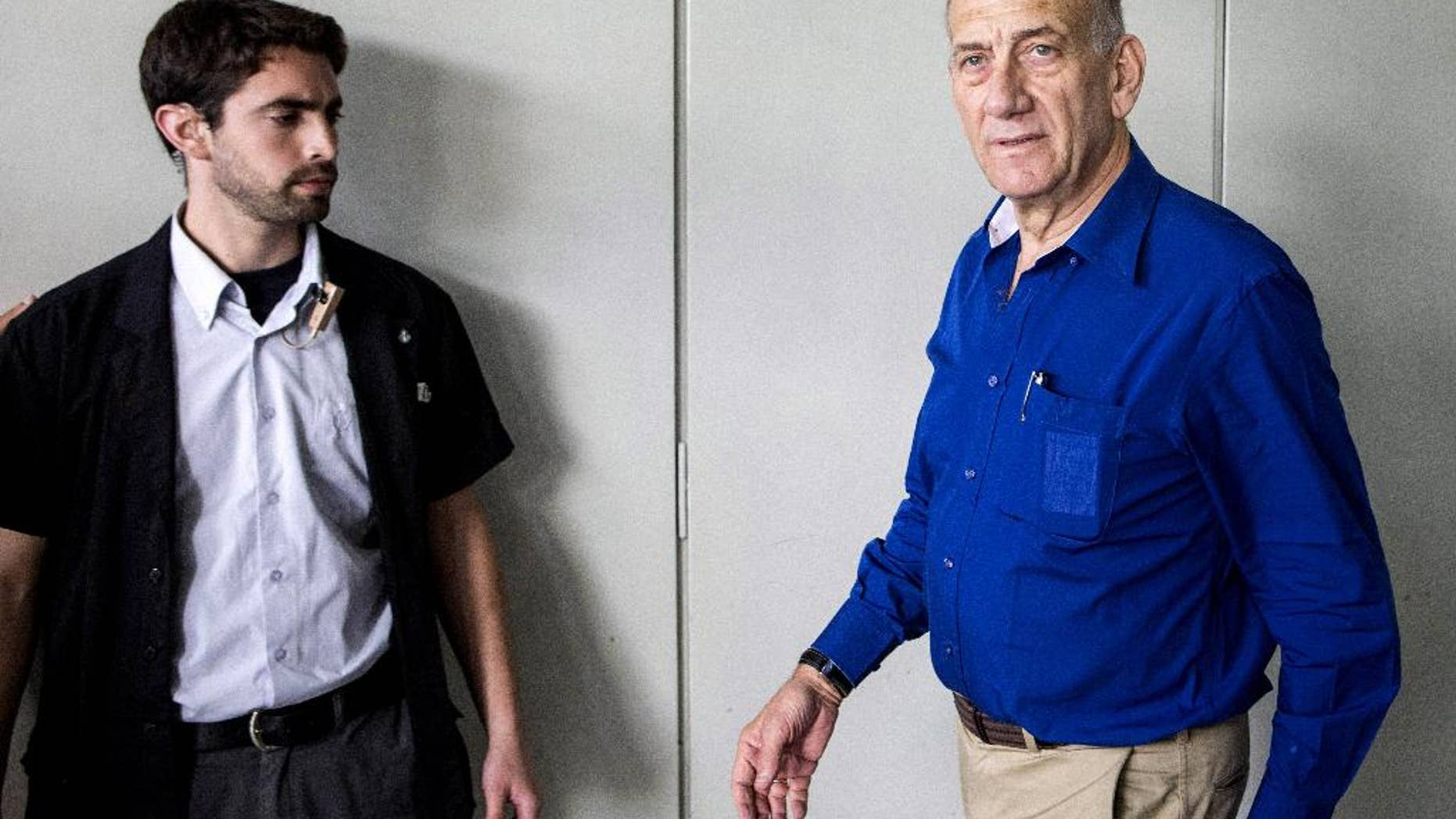 Israel's former Prime Minister Ehud Olmert arrives for his trial at the Tel Aviv District Court in Israel, Tuesday, May 13, 2014. Olmert was sentenced on Tuesday to six years in prison for his role in wide-ranging bribery case, capping a stunning fall from grace for one of the most powerful men in the country. (AP Photo/Jack Guez, Pool)