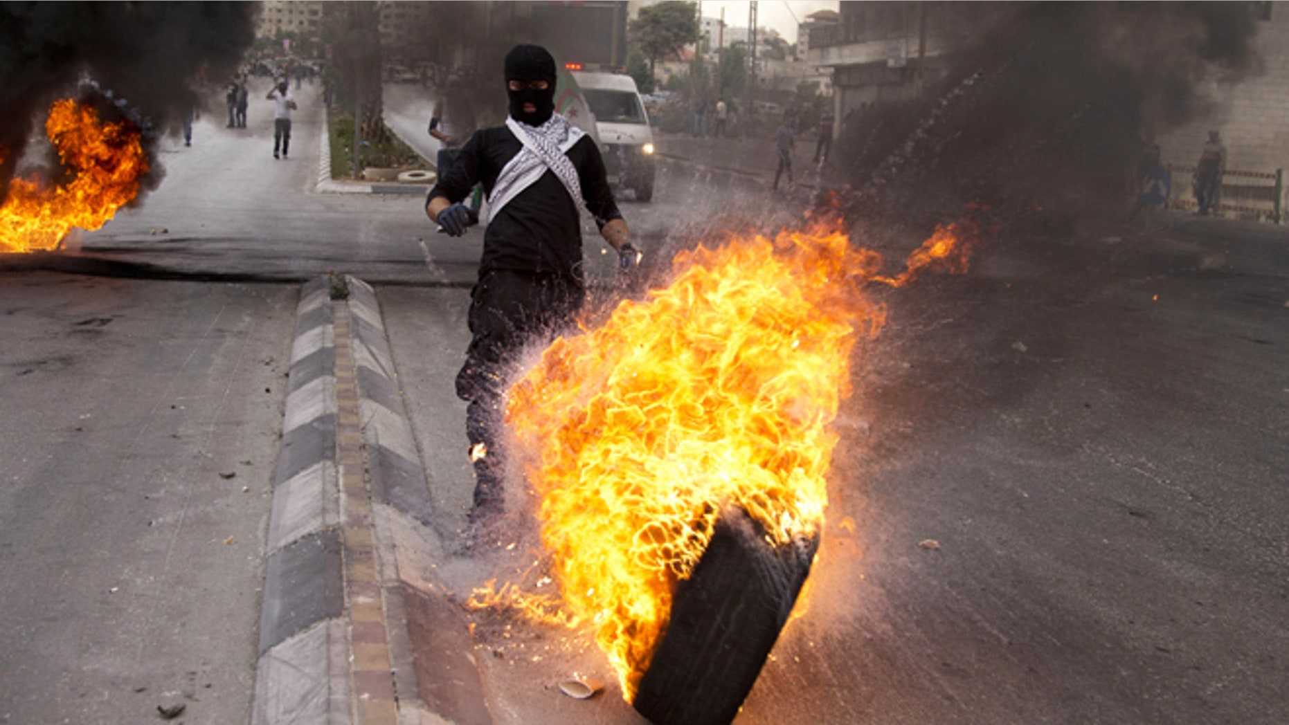Oct. 23, 2015: Palestinians burn tires during clashes with Israeli troops near Ramallah, West Bank.