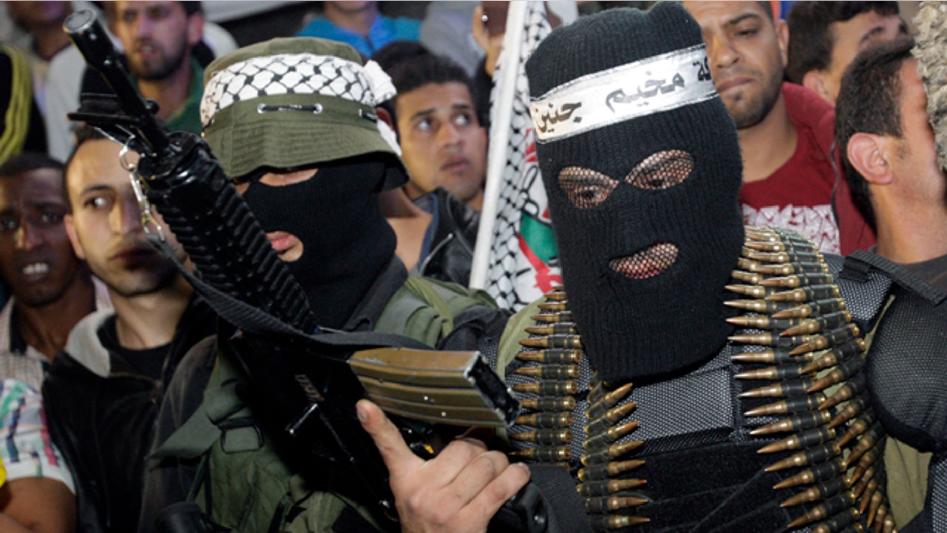 April 7, 2014: A Palestinian militant holds a weapon during a ceremony to mark the 12th anniversary of the Israeli army's 'Defensive Shield' operation in the West Bank refugee camp of Jenin. (AP Photo/Mohammed Ballas)