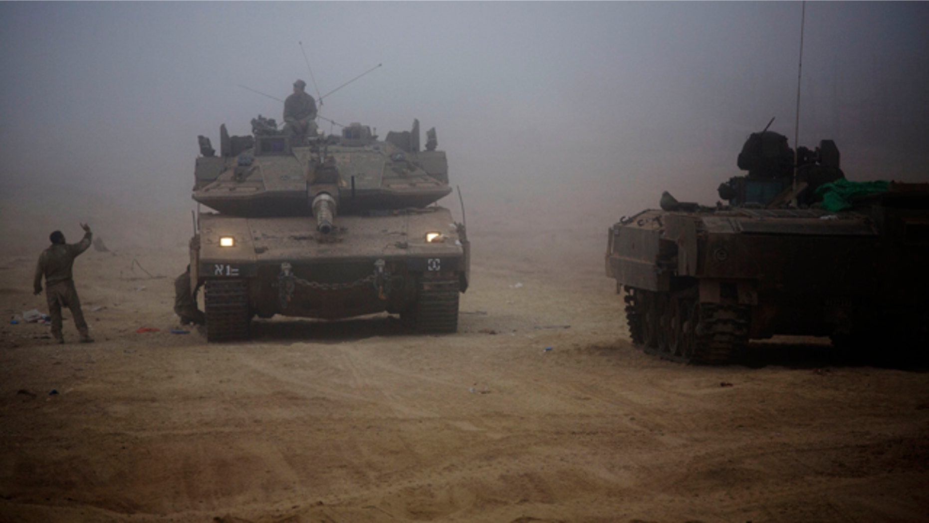 July 24, 2014: An Israeli tank moves through the morning mist near the Israel and Gaza border. (AP Photo/Dusan Vranic)