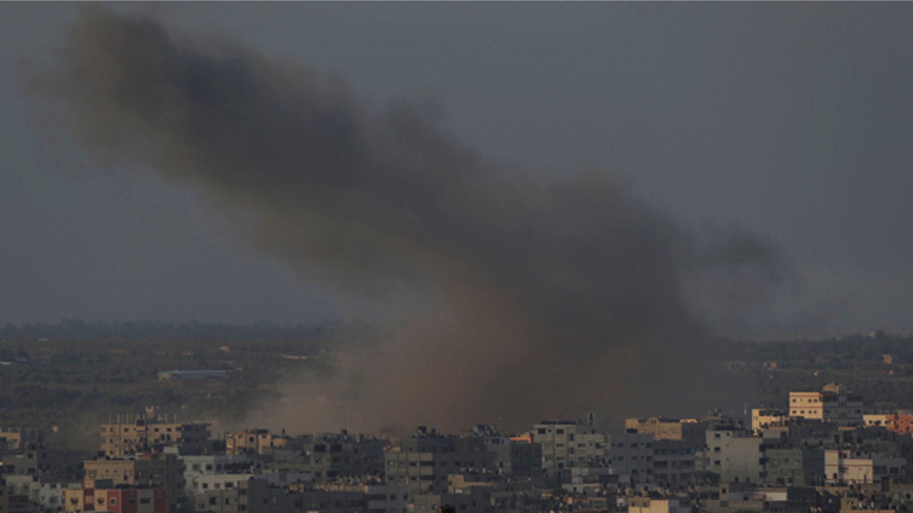 August 10, 2014: Smoke from an Israeli strike rises over Gaza City. (AP Photo/Lefteris Pitarakis)