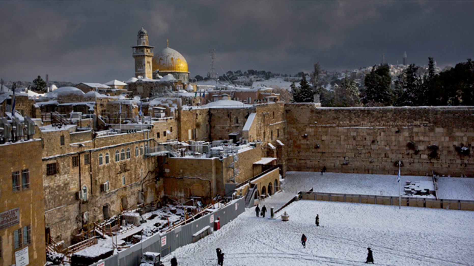 FILE - In this Dec. 13, 2013 file photo, the Western Wall, right, and the gilded Dome of the Rock, among the holiest sites for Jews and Muslims, are covered in snow. (AP Photo/Dusan Vranic, File)