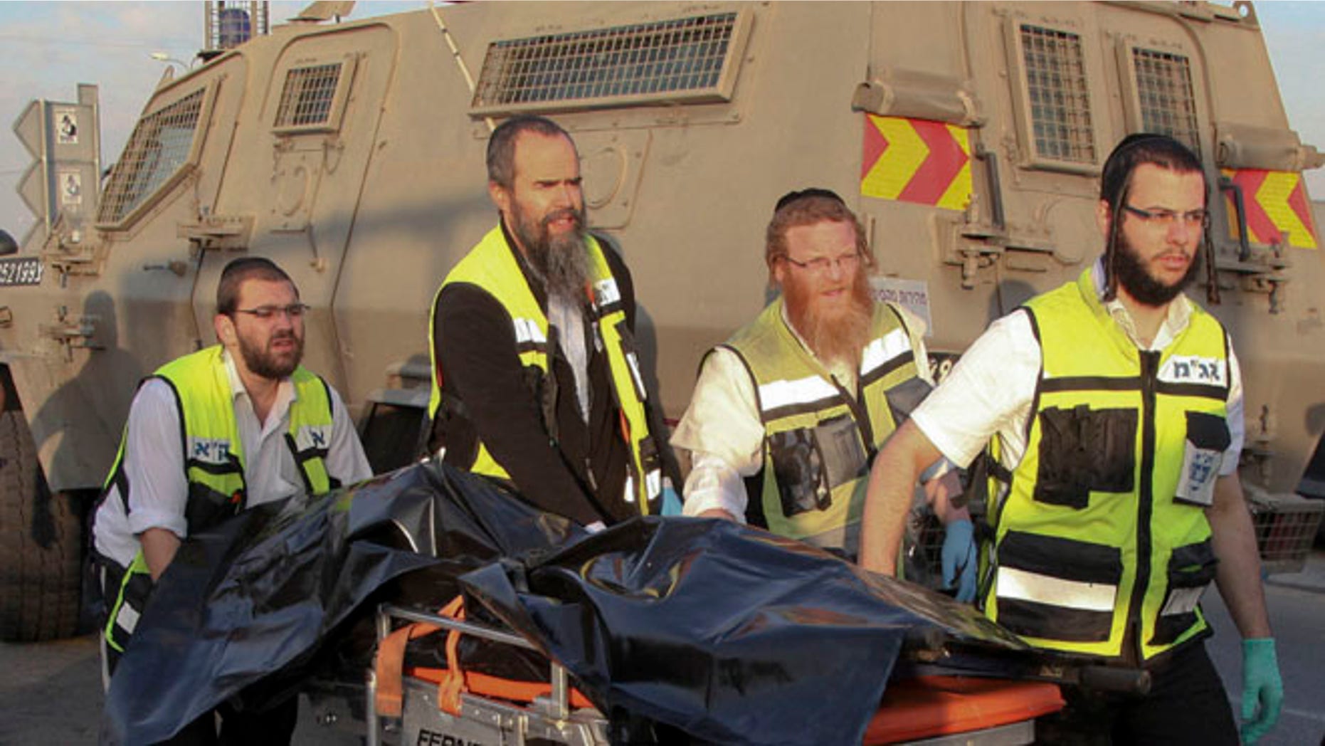 Israeli emergency services evacuate the body of a Palestinian from the scene of an attack near the West Bank Gush Etzion settlements.