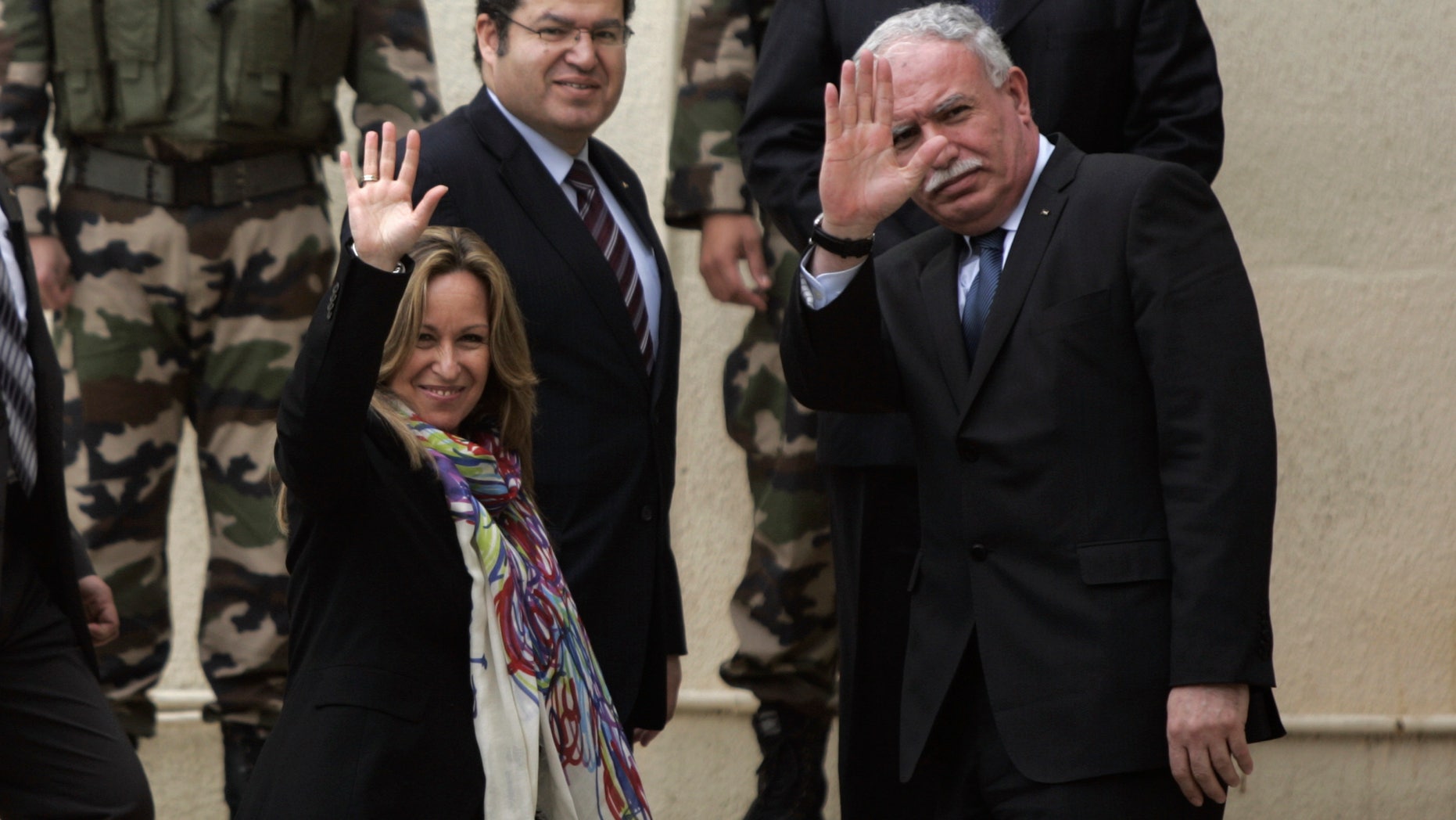 Feb. 9: Spain's Foreign Minister Trinidad Jimenez, left, waves to media members with her Palestinian counterpart Riad Malki, right, as they arrive for a meeting with Palestinian President Mahmoud Abbas, not seen, in the West Bank city of Ramallah.