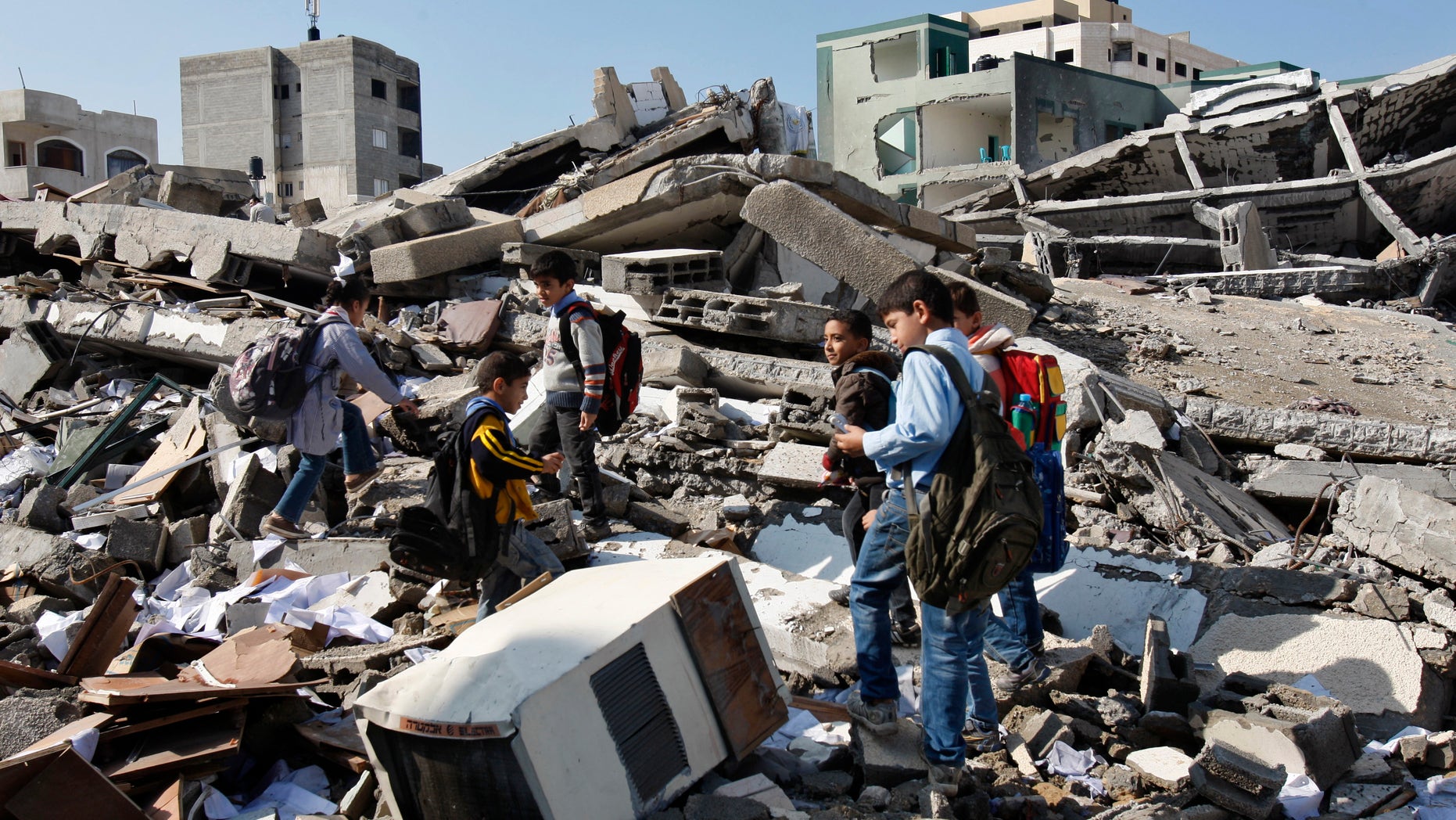 Nov. 26, 2012 - Palestinian school children walk in the rubble left days after an Israeli strike destroyed the Hamas interior ministry in Gaza City.