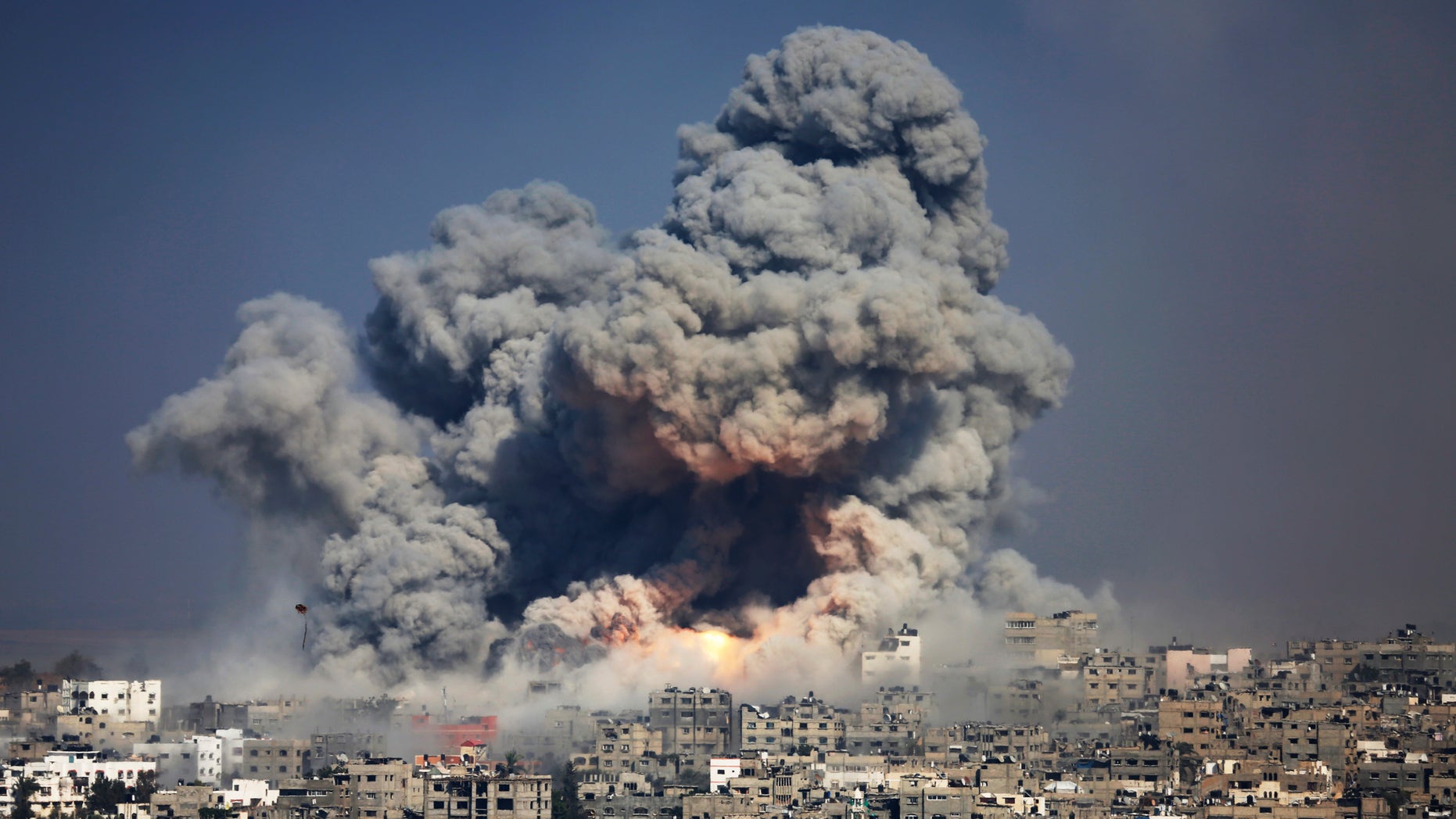 FILE photo from July 29, 2014 showing smoke and fire from the explosion of an Israeli strike over Gaza City. A much-awaited UN report into the 2014 Gaza war released Monday, found that both Israel and Palestinian militant groups may have committed war crimes during the conflict.