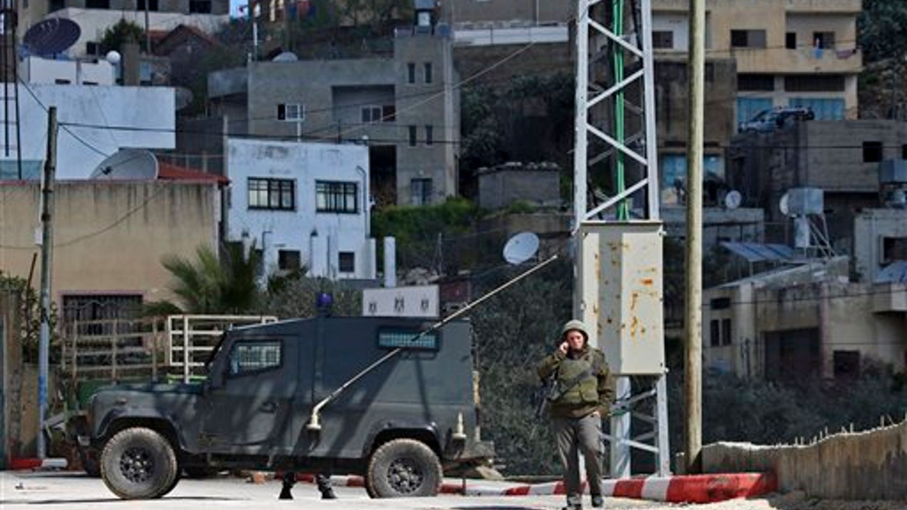 March 12: Israeli troops operate in the West Bank village of Awarta, after five people were killed in the nearby Jewish settlement of Itamar. A Palestinian infiltrated Itamar early Saturday and killed five people, the Israeli military said. Israeli media is reporting that the dead are all members of the same family with parents and three children aged 11, 3 and an infant, all reported to have been stabbed while they slept. (AP)