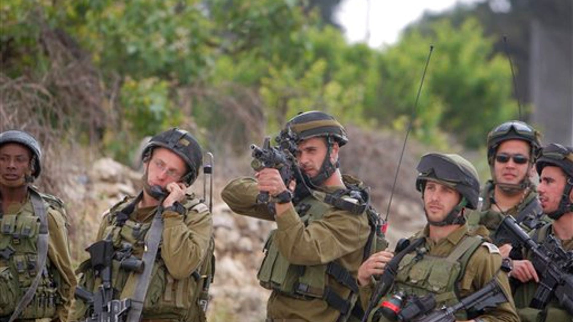 May 15: Israeli soldiers take positions as Palestinian youths, not seen, hurl stones during clashes at the Al-Roub refugee camp near the West Bank city of Hebron. The clashes erupted following a demonstration to mark the 63rd anniversary of "Naqba", Arabic for "Catastrophe", the term used to mark the events leading to Israel's founding in 1948. (AP)