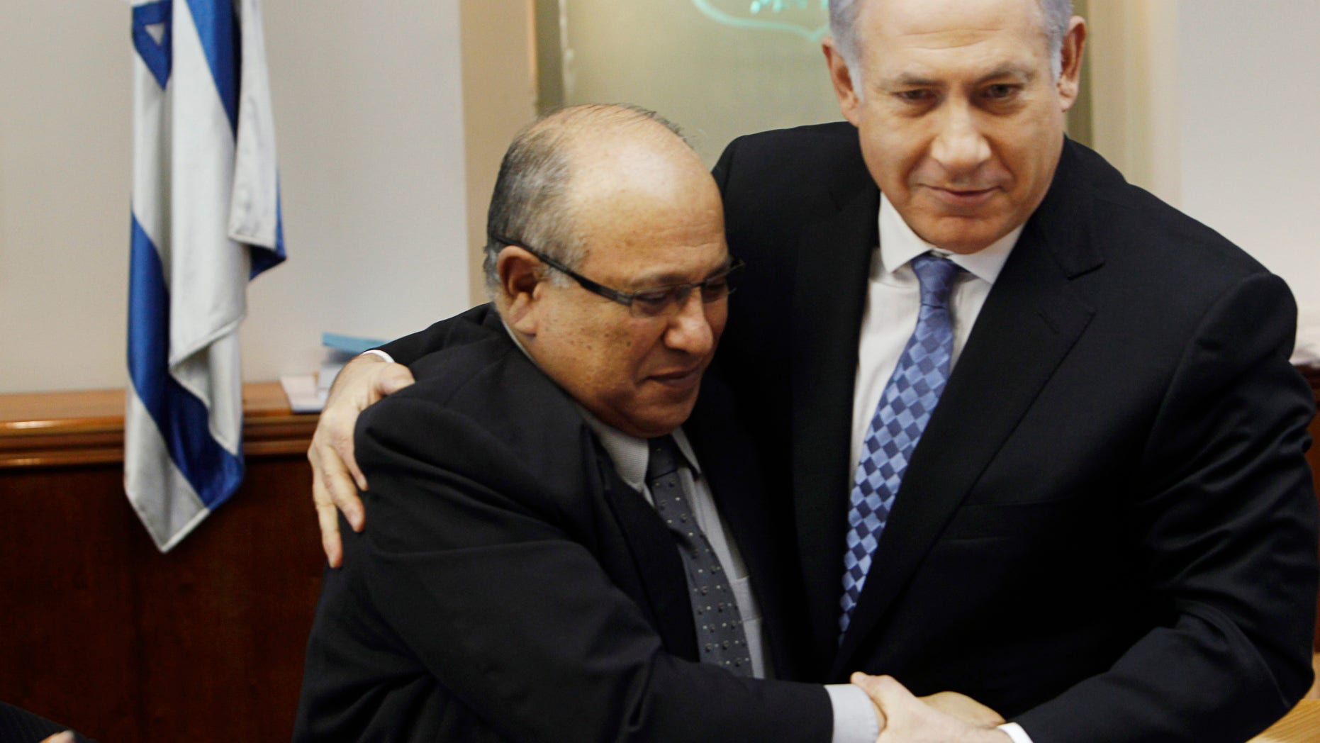 In this Jan. 2, 2011 file photo, Israel's Prime Minister Benjamin Netanyahu, right, hugs Meir Dagan, then outgoing Mossad chief, after thanking him at the beginning of the weekly cabinet meeting in Jerusalem. Israeli media on Thursday, 2 June, 2011, cite the recently retired Mossad chief Meir Dagan as saying there are no plans to attack Iran within the next two years. (AP/File)