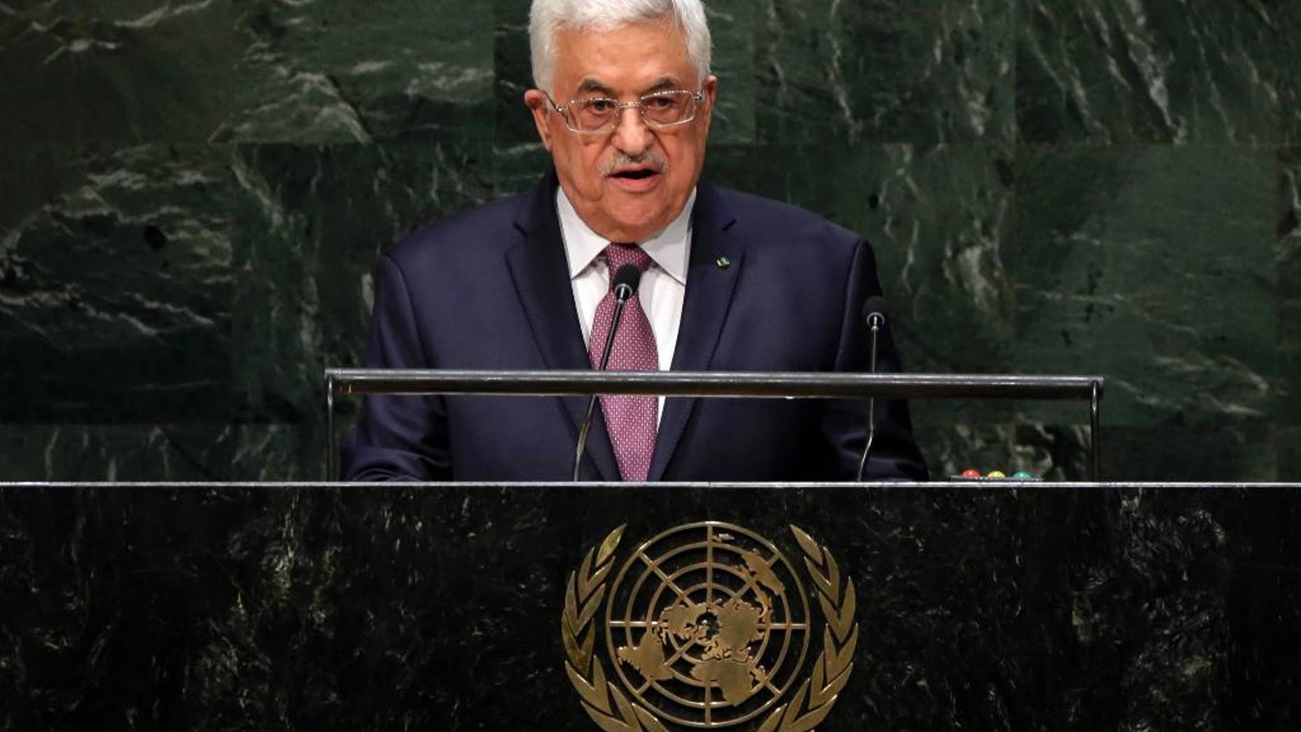 FILE - In this Friday, Sept. 26, 2014, file photo, Palestinian President Mahmoud Abbas addresses the 69th session of the United Nations General Assembly at U.N. headquarters. The U.N. has accepted Palestine's request join the International Criminal Court, setting April 1 as the starting date and clearing the way for potential war crimes investigations of Israel over its settlement building on occupied lands and a 2014 war in Gaza that killed hundreds of civilians. (AP Photo/Richard Drew, File)