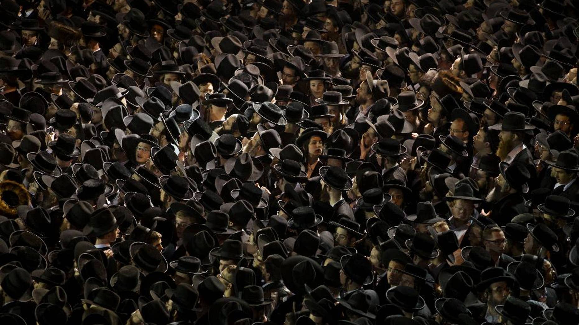 FILE - In this Thursday, May 16, 2013 file photo, thousands of ultra-Orthodox Jews gather near an Israeli Defense Forces recruitment center during a protest against military conscription of yeshiva students, in Jerusalem. The formation of Benjamin Netanyahu’s new coalition government has cleared the way for the country’s ultra-Orthodox parties to return to power after two years in the opposition. This religious resurgence could have deep implications as they seek to reinstate a system of subsidies and preferential treatment that have long angered the country’s secular majority, potentially setting the stage for a new round of culture wars that recently have plagued Israel. (AP Photo/Bernat Armangue, File)