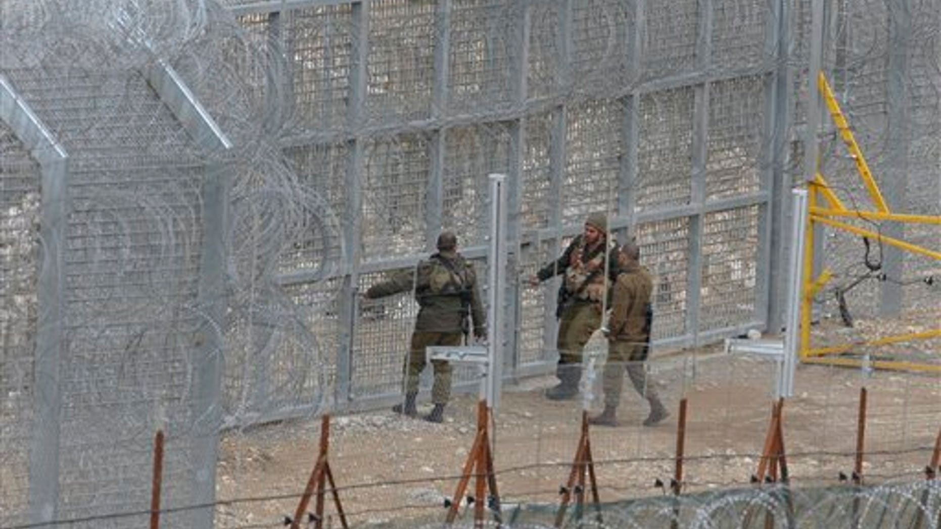 March 29: Israeli soldiers stand on the border fence between Majdal Shams in the Golan Heights, and Syria, as security is tightened ahead of Land Day.