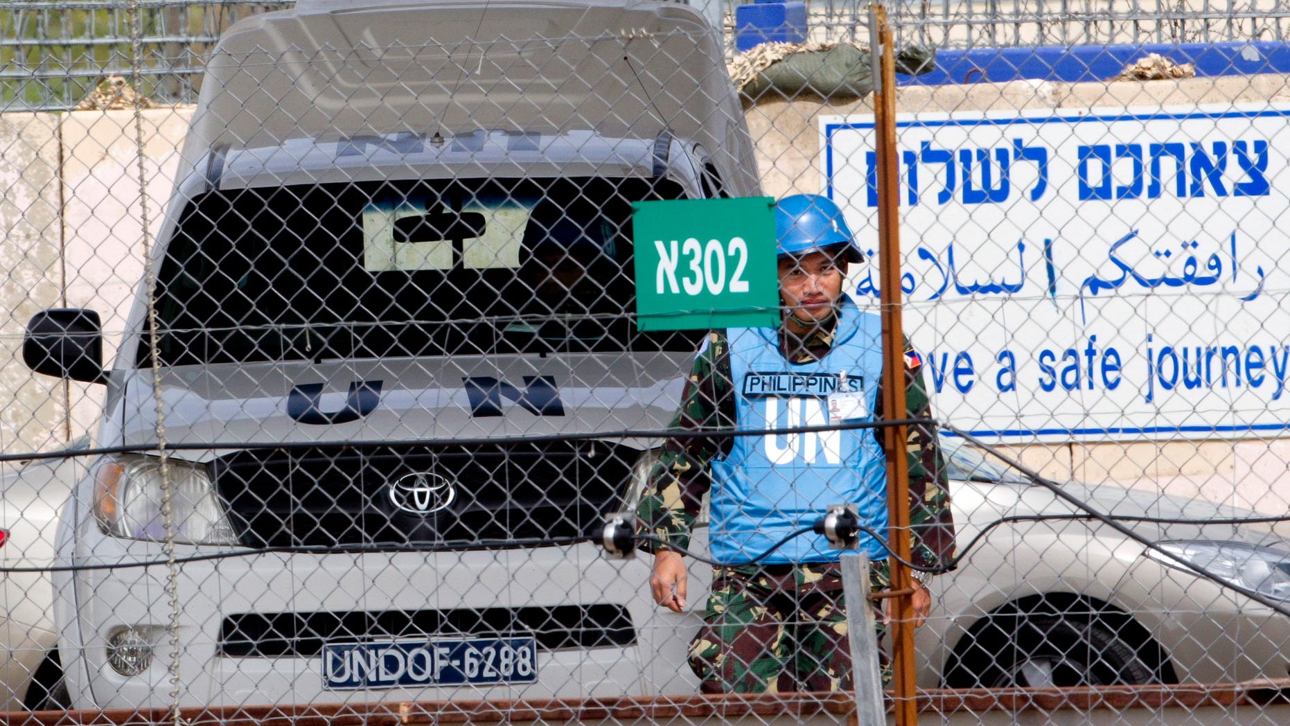 March 7, 2013 - A U.N. peacekeeper from the Philippines crosses back from Syria at the Quneitra Crossing between Syria and the Israeli-controlled Golan Heights.