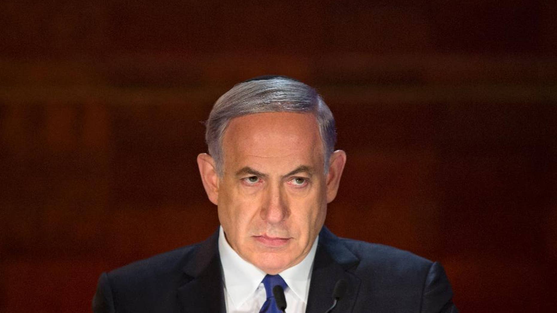 FILE - In this Wednesday, April 15, 2015 file photo, Israeli Prime Minister Benjamin Netanyahu looks on as he speaks at the opening ceremony of the Holocaust Remembrance Day at the Yad Vashem Holocaust Memorial in Jerusalem. Netanyahu has managed to cobble together a government dominated by nationalist and religious allies, setting the stage for conflict with the Palestinians and much of the world and leaving Israel angrily divided. (AP Photo/Sebastian Scheiner)