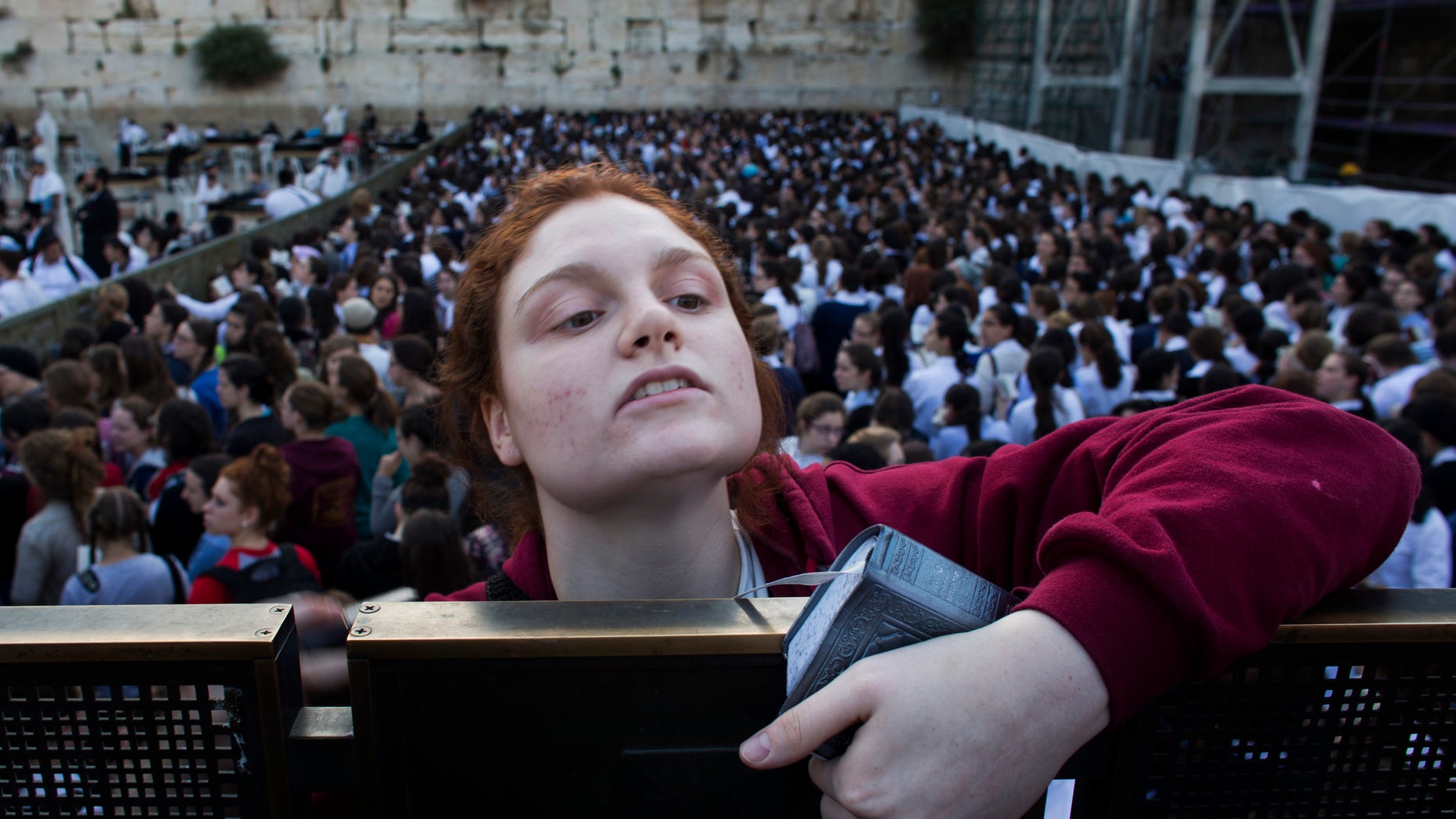 May 10, 2013: A Jewish orthodox women follows a prayer organized by the "Women of the Wall" organization, not pictured, at the Western Wall, the holiest site where Jews can pray in Jerusalem's old city.