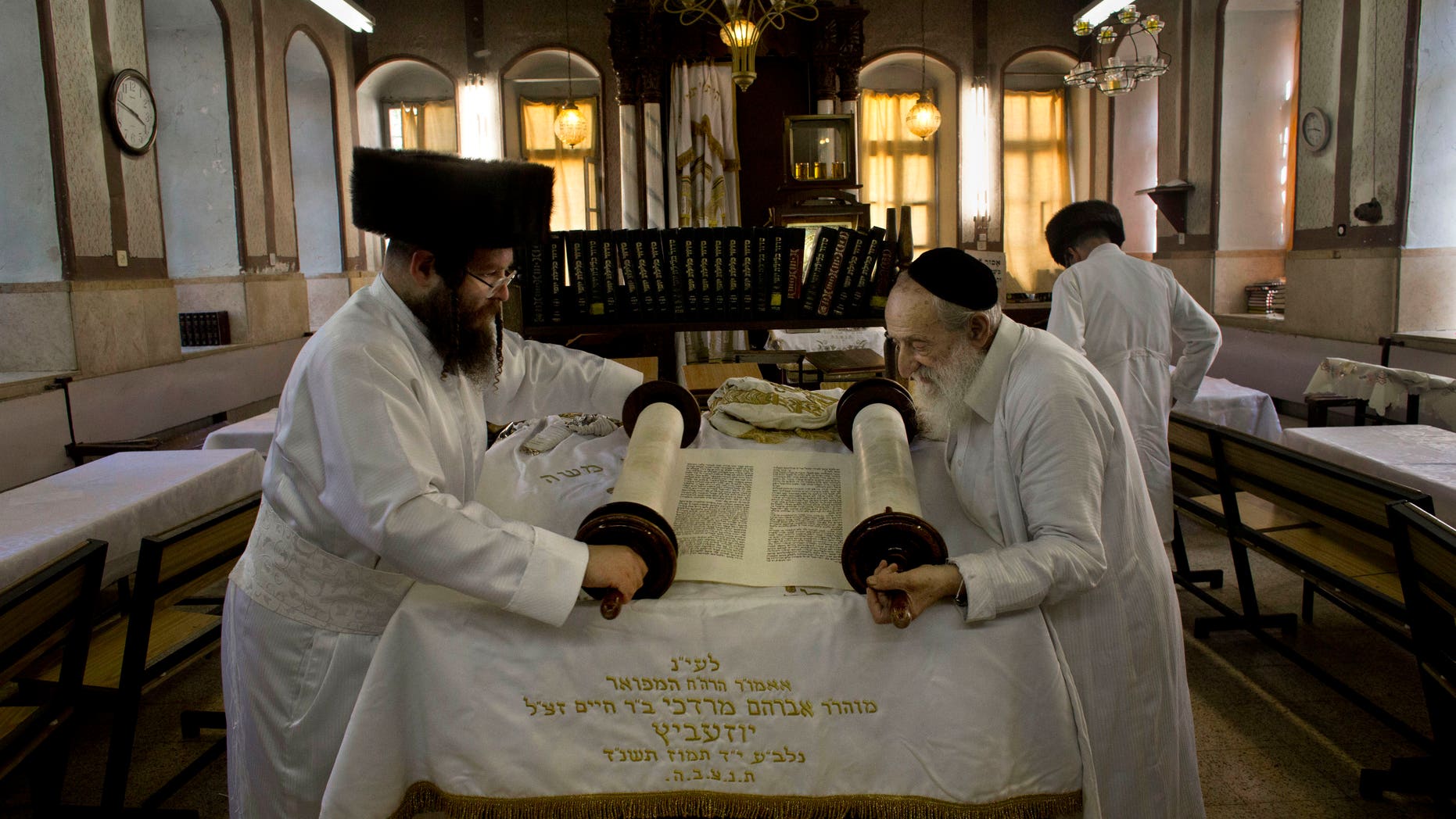 Sept. 13, 2013 - Ultra-Orthodox Jewish men roll a torah scroll ahead of Yom Kippur, in Jerusalem. Yom Kippur is Judaism's day of atonement, when devout Jews ask God to forgive them for their transgressions and refrain from eating and drinking, attending intense prayer services in synagogues.