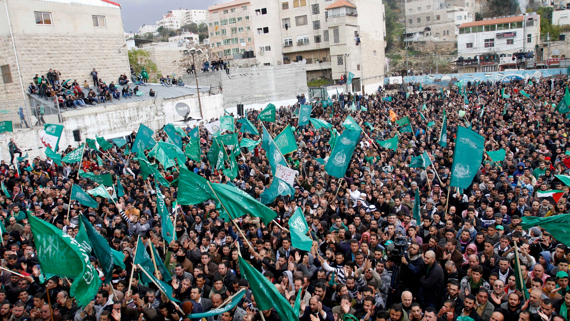 Dec. 14, 2012 - Palestinian supporters of Hamas gather during a rally to celebrate the 25th anniversary of the militant group, in the West Bank city of Hebron.