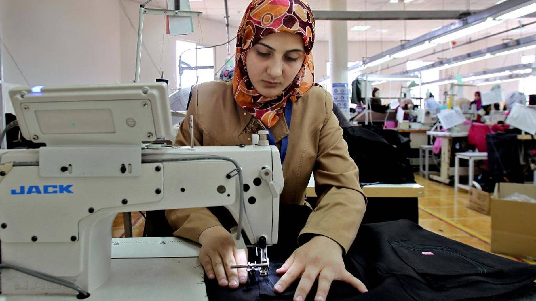 May 20, 2015: Jordanian women sew jeans for the U.S. market in a garment factory in the village of Kitteh in northern Jordan. The factory opened last year and created employment in an area where options had largely been limited to men joining the army and women staying home.