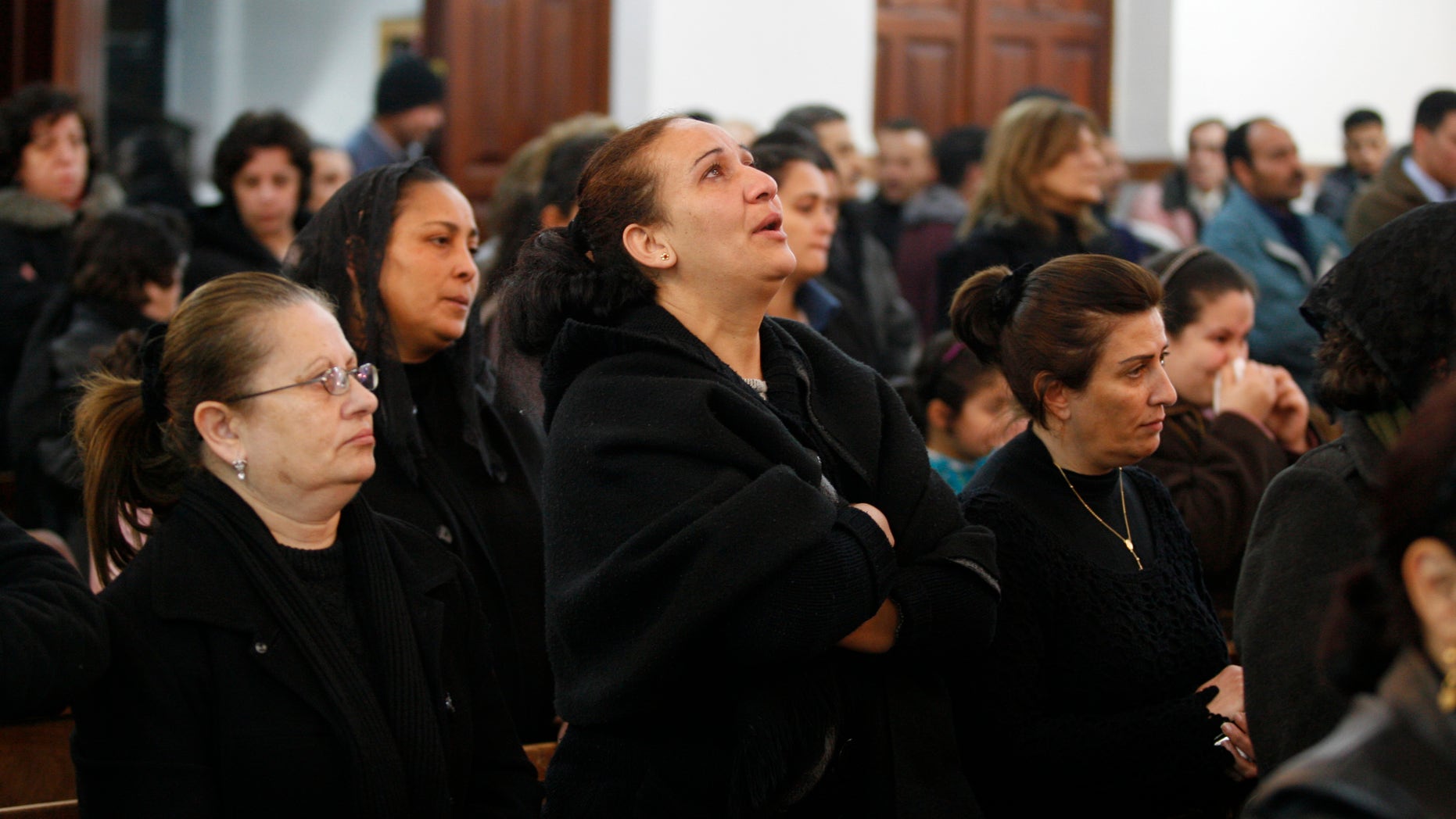 Jan. 5, 2011: An Egyptian Coptic woman, center, reacts during a prayer ceremony for the victims who died after New Year's Day church bombing that killed 21 people, at the Coptic Orthodox Church in Amman, Jordan.