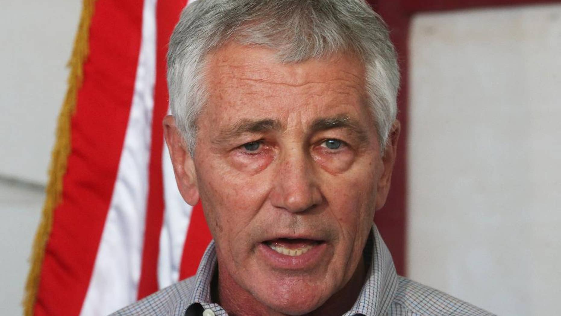 U.S. Secretary of Defense Chuck Hagel speaks during a press conference after visiting U.S. troops in Kuwait City, Monday, Dec. 8, 2014. Hagel visited the camp which once was a staging post for troops headed to Iraq. (AP Photo/Mark Wilson, Pool)